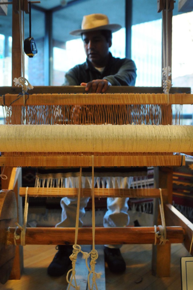 Jose Buenaventura Gonzalez Gutierrez weaves an Oaxacan rug at an Indigenous craft bazaar hosted by Cultural Survival, an organization that works for indigenous rights and cultures around the world,  Sunday. 