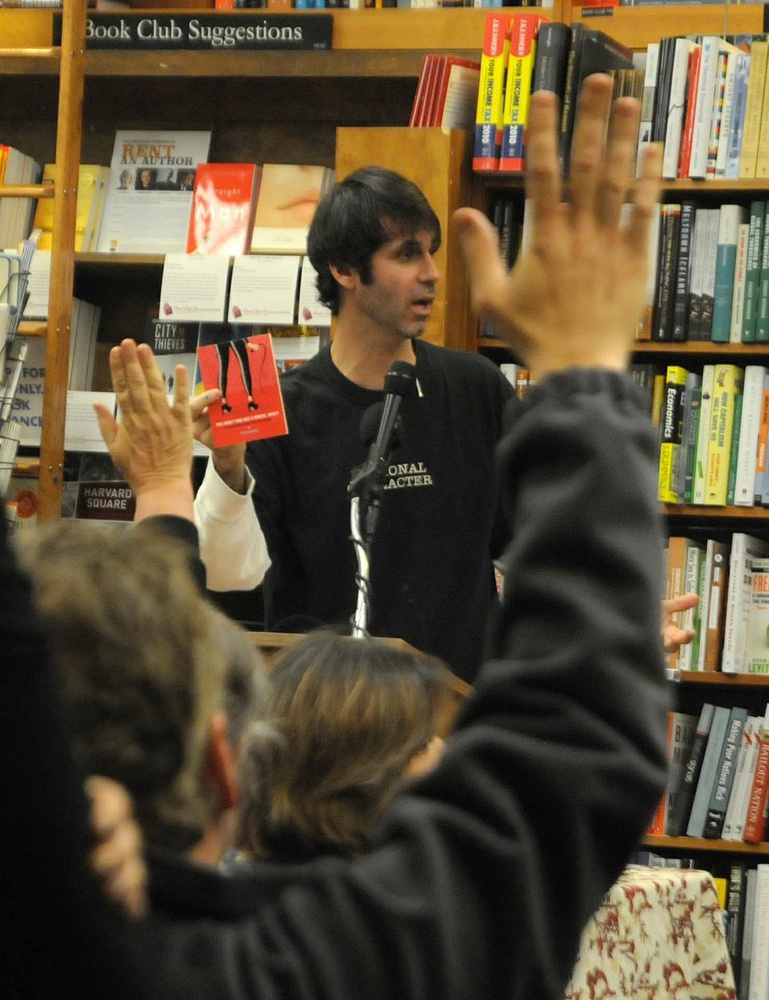 Writer Steve Almond reads from his new collection, This Won't Take But a Minute, Honey, at the Harvard Bookstore yesterday. The book is being printed on demand on the store's espresso book machine. Because the book has multiple covers and it is being printed on demand,  Almond takes a show of hands from audience members to see how many book with each cover to print.