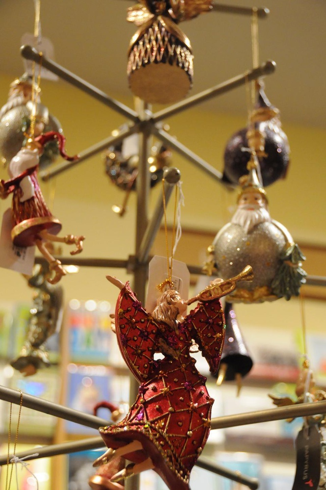 Colorful angel ornaments and other traditional Christmas charactes contribute to a festive store display at Papyrus.