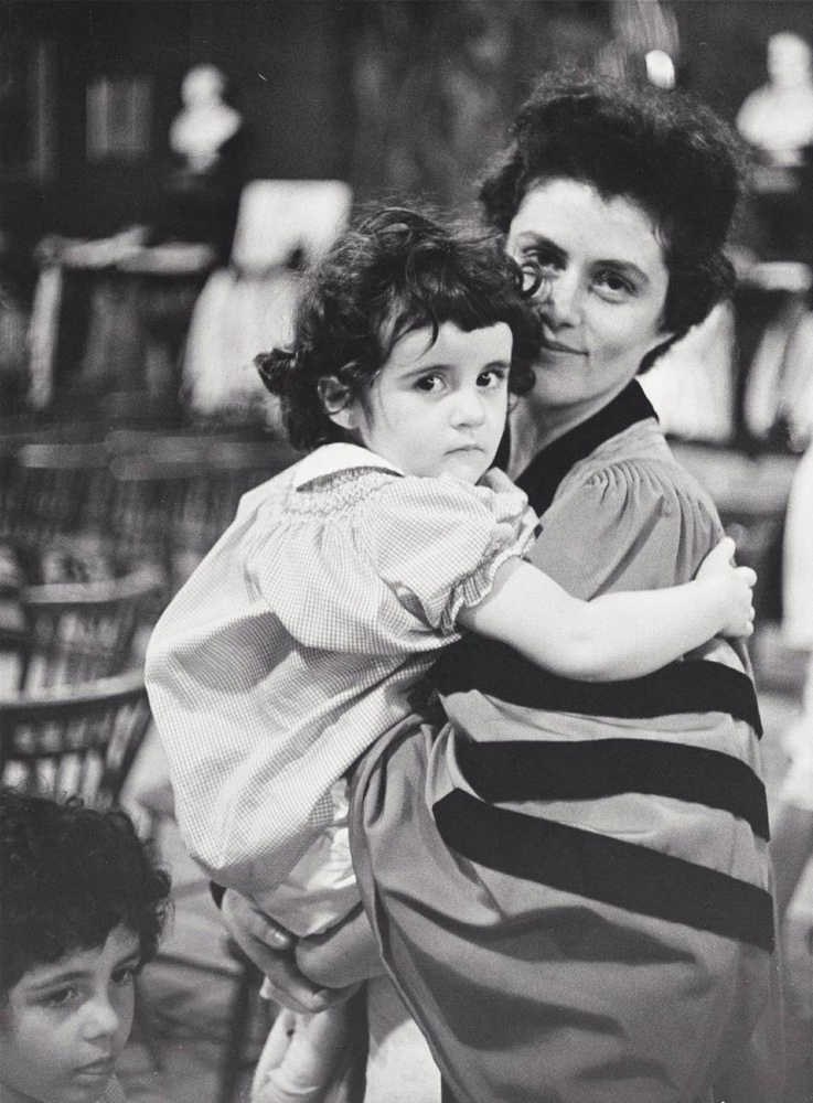 Alma Arbos, who received her Ph.D from Radcliffe in 1962, holds with her daughter during the Radcliffe Commencement ceremony. Radcliffe President Mary I. Bunting-Smith encouraged mothers to complete their degrees.