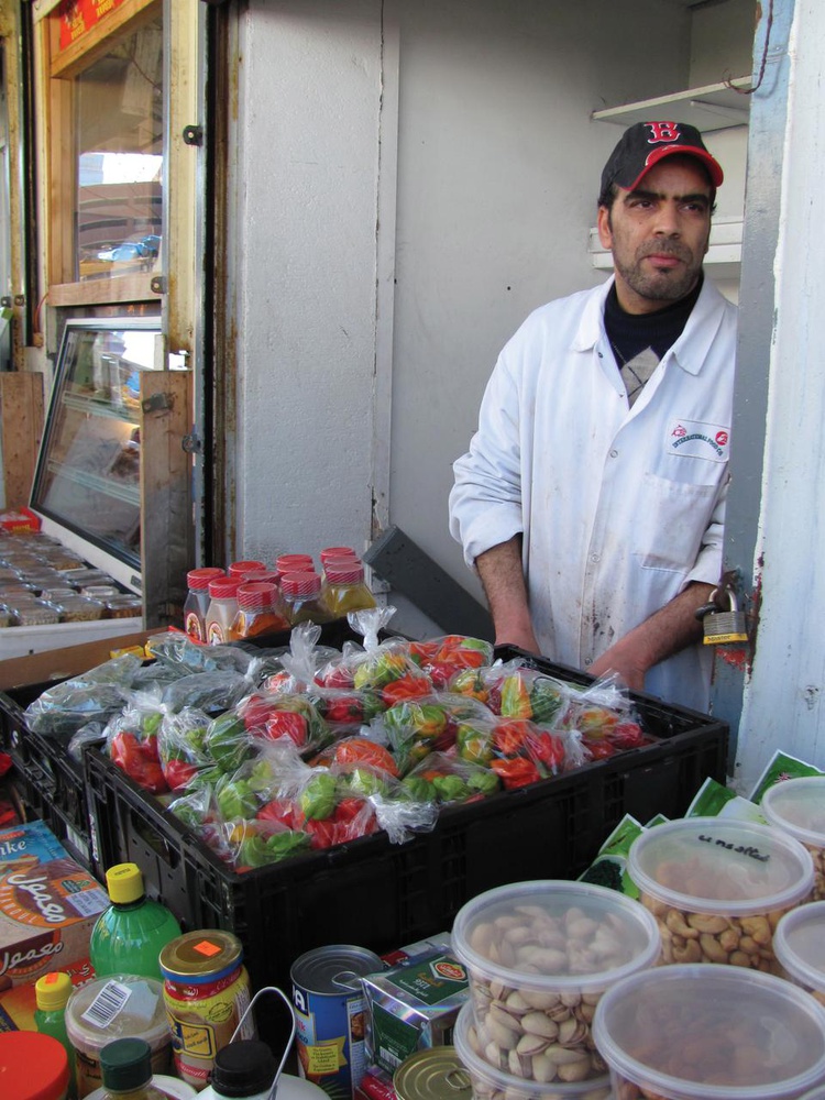 This street vendor’s wares include an interesting mixture of bags of bell peppers, nuts, and Middle Eastern candies. 