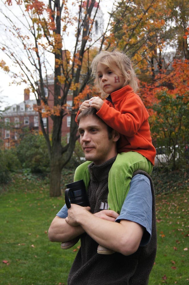 Brad J. Molyneaux holds his daughter Nora J. Molyneaux on his shoulders as they both enjoy the talents of the various bands.      