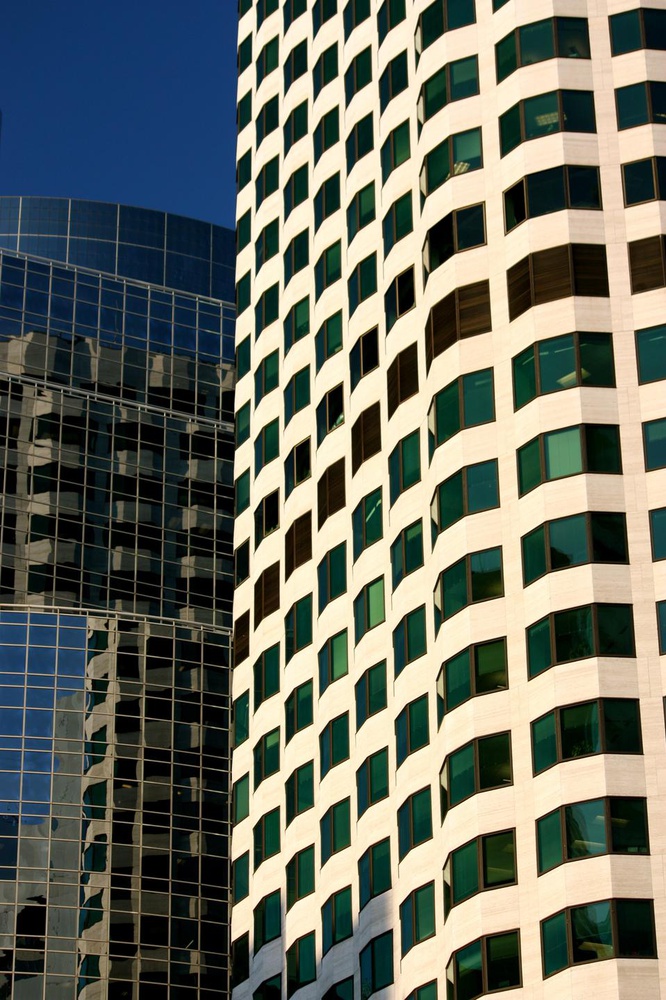Towers made up of mainly glass, steel and concrete are representative of the modernist style of architecture found throughout the financial district of Boston.