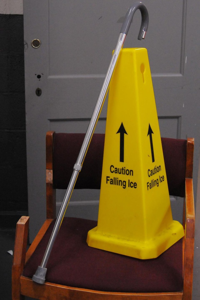 A cane and a caution sign take a seat after being dug up in the trash room of Wigglesworth. 
