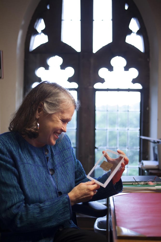 Professor Karen L. King is shown holding the fragment of ancient papyrus that contains four words suggesting that early Christians believed Jesus was married.