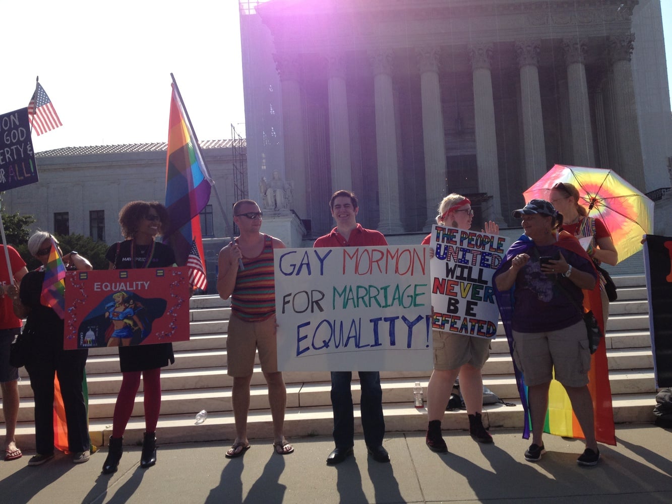 Holding colorful signs and waving rainbow flags, supporters of same-sex marriage gather outside the U.S. Supreme Court before the announcement of rulings on cases concerning California's Proposition 8 and the Defense of Marriage Act.