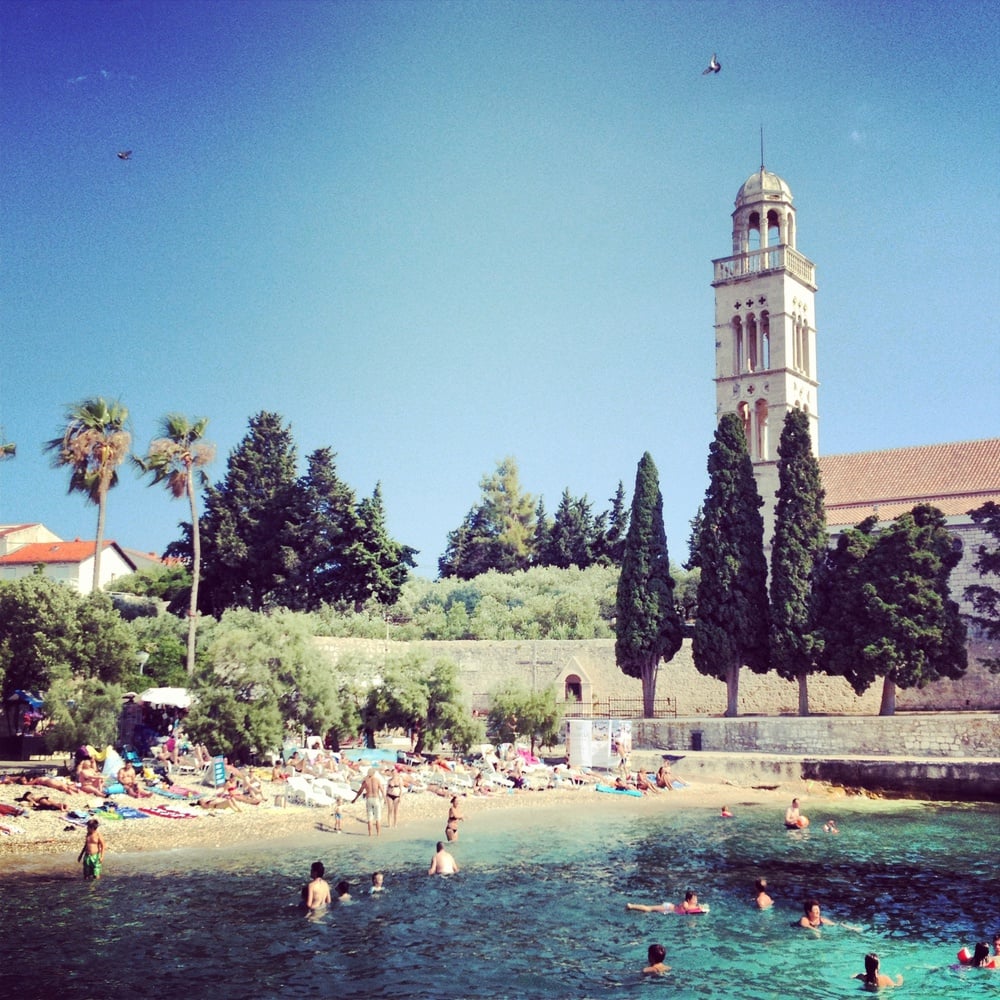 Noontime beach-goers enjoy one of many sandy beaches in Hvar, an island off the coast of Croatia