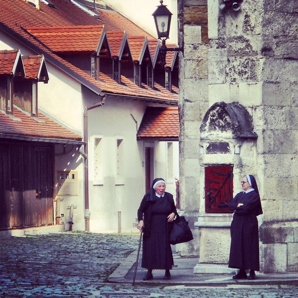 Two nuns converse outside Zagreb's Cathedral of the Assumption of the Virgin Mary.