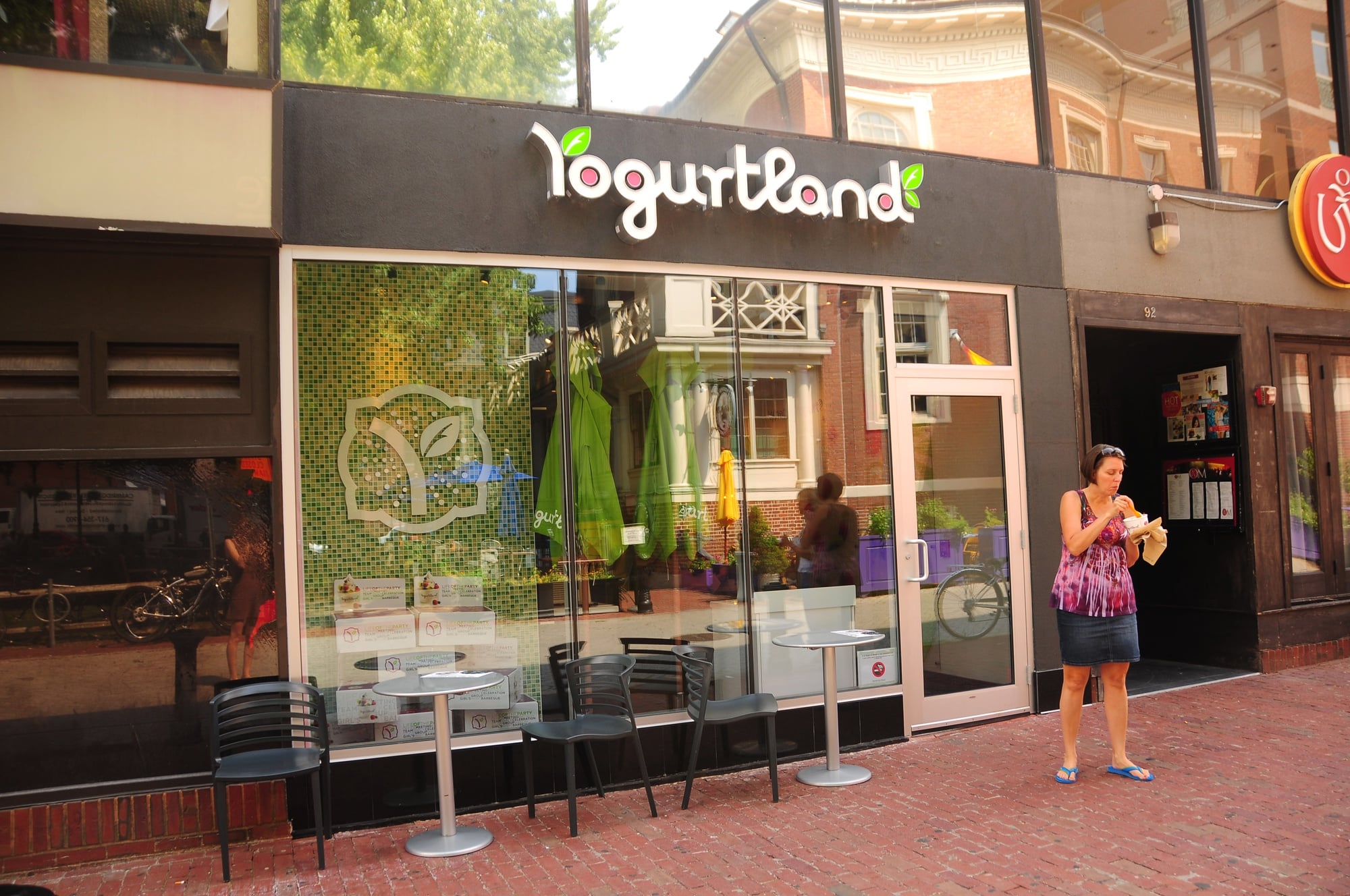Yogurtland patron Debbie Marujo exits the new frozen yogurt joint, chocolate and pistachio froyo in hand. 
