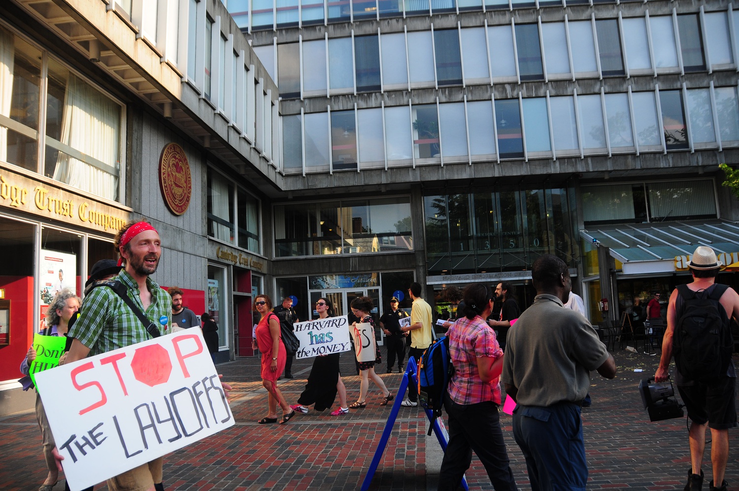 Protesters march late Friday afternoon outside of Holyoke Center, chanting in support of University workers. The group rallied in protest of what they claimed was discrimination and retaliation against union involvement on the part of the University.
