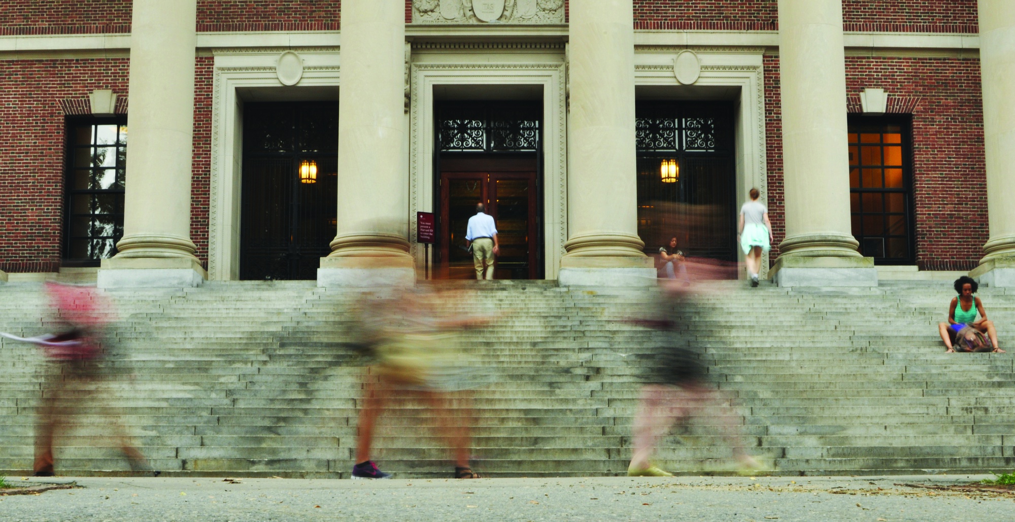 Students walk past Widener steps on Tuesday morning, beginning the academic year on a humid September day. Shopping week will continue until Tuesday, at which point students are expected to have solidified their course schedules.