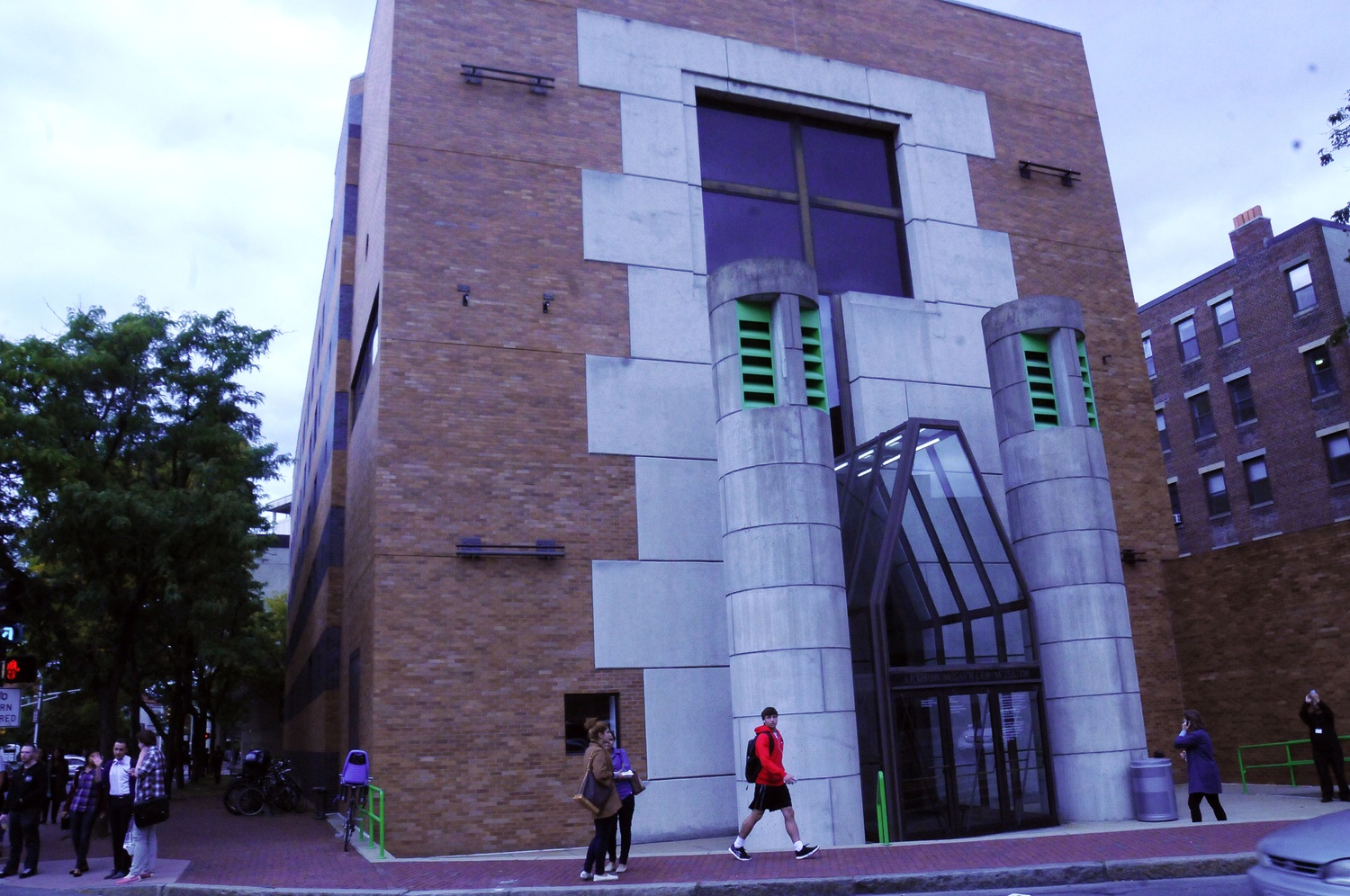 Students and members of the community create a lively atmosphere in and around the geometric entrance of the Arthur M. Sackler Museum.