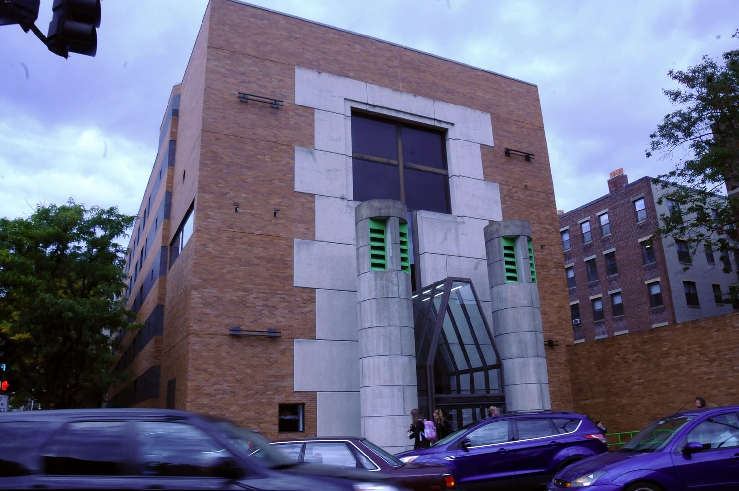 Cars drive past the busy geometric entrance of the Arthur M. Sackler Museum on Wednesday afternoon.