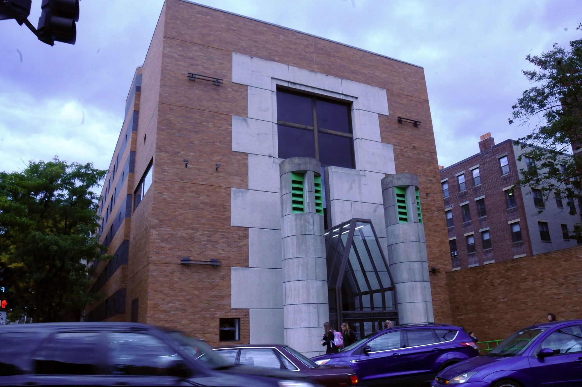 Cars drive past the busy geometric entrance of the Arthur M. Sackler Museum on Wednesday afternoon.