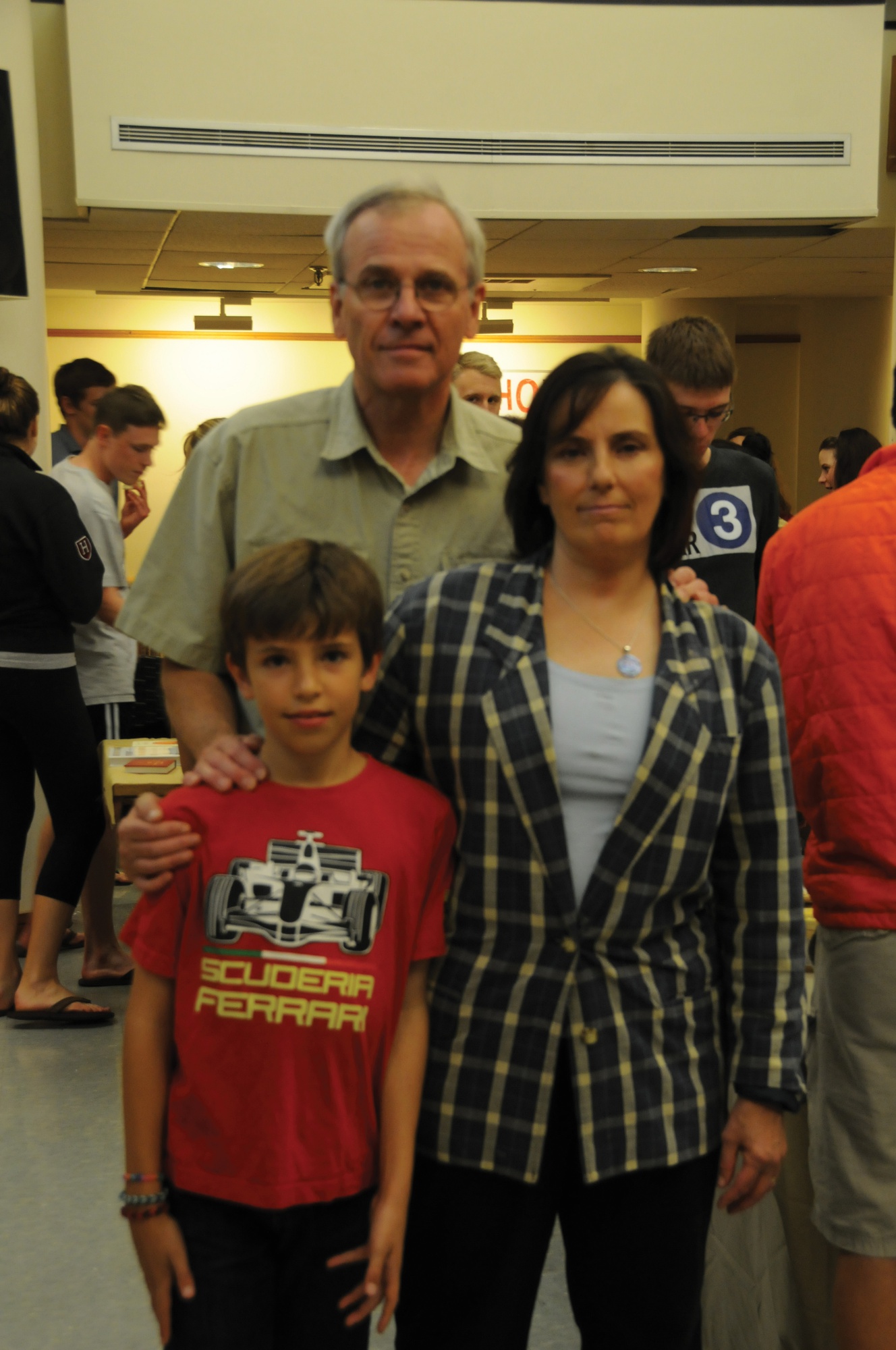Pforzheimer House Co-Masters Anne Harrington and John Durant pose in the Pfoho dining hall with their son Jamie Durant on Sunday night before a harvest house event. 