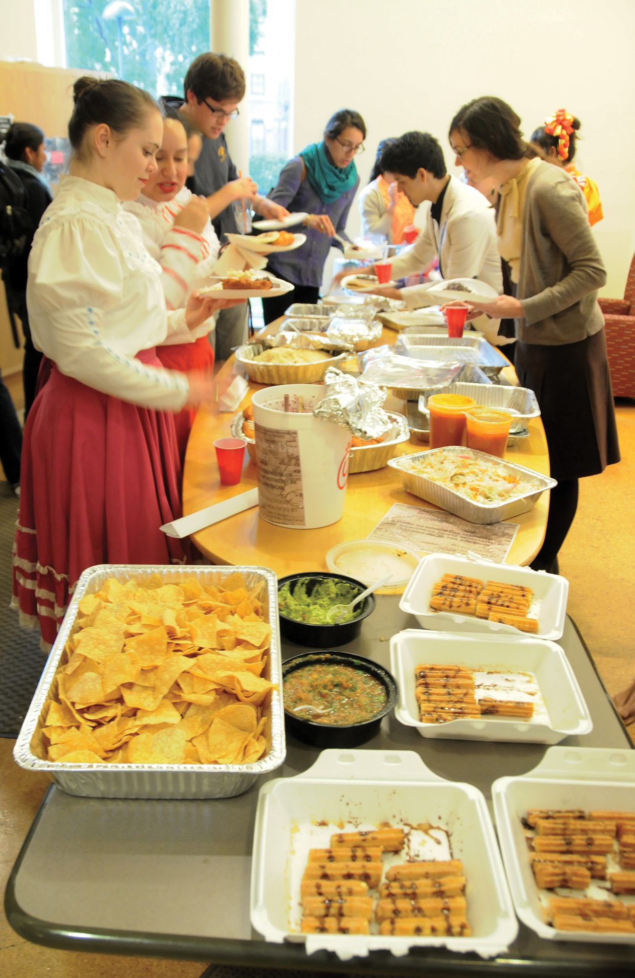 Students and performers serve themselves traditional cultural food at an Indigenous People's Day event sponsored by Native Americans at Harvard College (NAHC), HOLA, RAZA, Fuerza, and Ballet Folklorico. This event also included performances by Ballet Folklorico, Urban Thunder (Native American Drum Group) and spoken word pieces with the aim of celebrating the strength of the Indigenous People affected by colonialism in the Americas. 