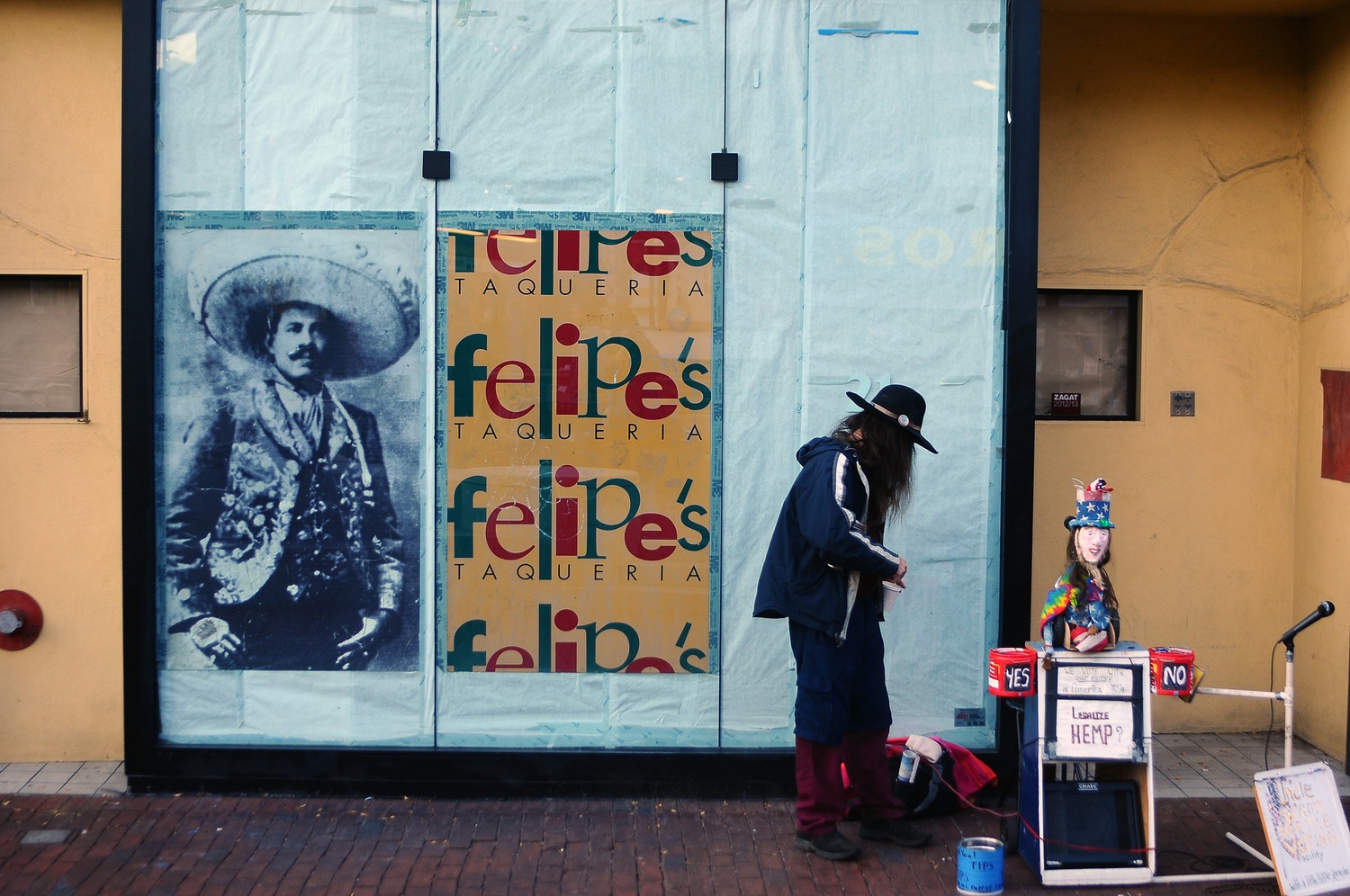 A street performer stands in front of the vacant Brattle St. building that will hold the relocated Felipe's Taqueria, set to open in February 2014. Felipe's will move from its long-time location in the Garage to the space formerly occupied by Bertucci's, the Harvard Square Italian eatery that closed in August.