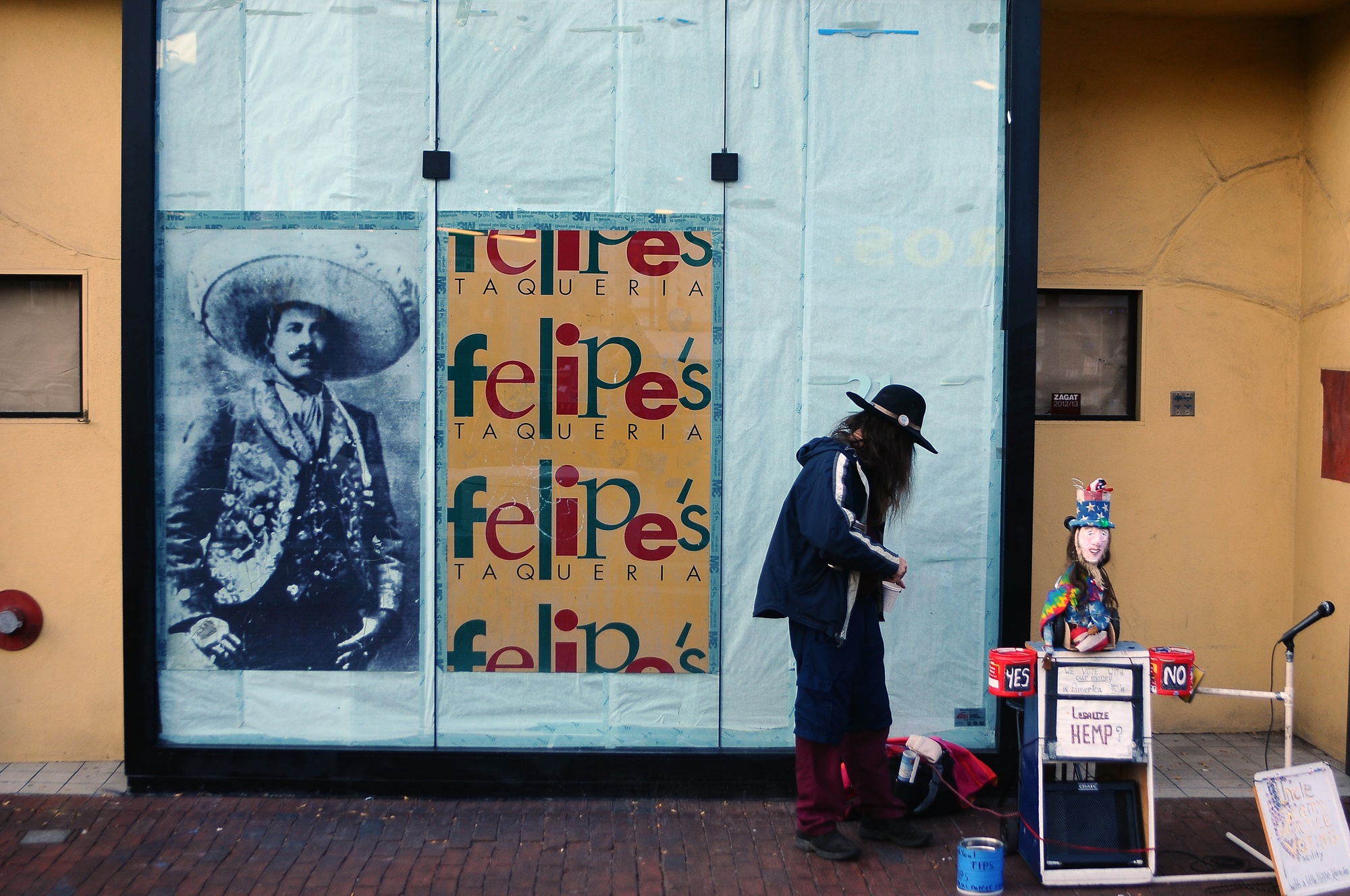 A street performer stands in front of the vacant Brattle St. building that will hold the relocated Felipe's Taqueria, set to open in February 2014. Felipe's will move from its long-time location in the Garage to the space formerly occupied by Bertucci's, the Harvard Square Italian eatery that closed in August.
