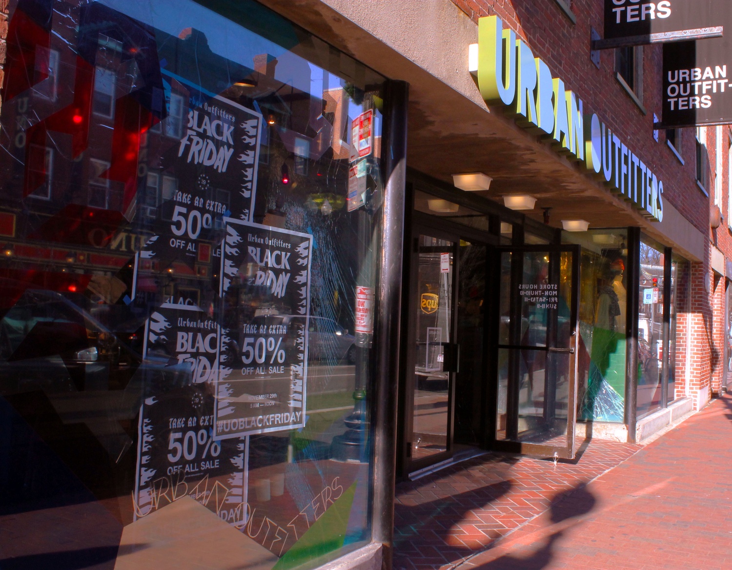 Urban Outfitters in Harvard Square attracts customers with Black Friday posters early in the week. Local businesses rather than large stores like Urban Outfitters will be promoted in Harvard Square after Thanksgiving.
