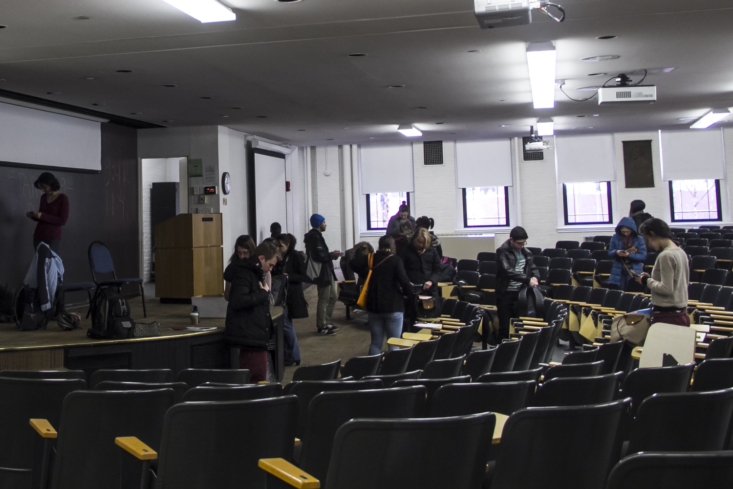 Students pack up their belongings and leave Geological Lecture Hall after taking their Life Sciences 1a final examination. The exam continued as information about the explosives threat came through.