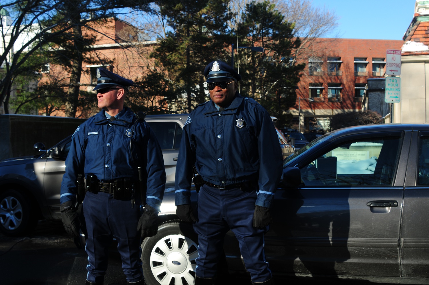 Massachusetts State Police officers wait on Kirkland St. Monday afternoon after reports of explosives in four Harvard buildings. CORRECTION: Dec. 16, 2013: An earlier version of this caption incorrectly identified the street where the Mass. State Police were were waiting. In fact, it was Kirkland St.