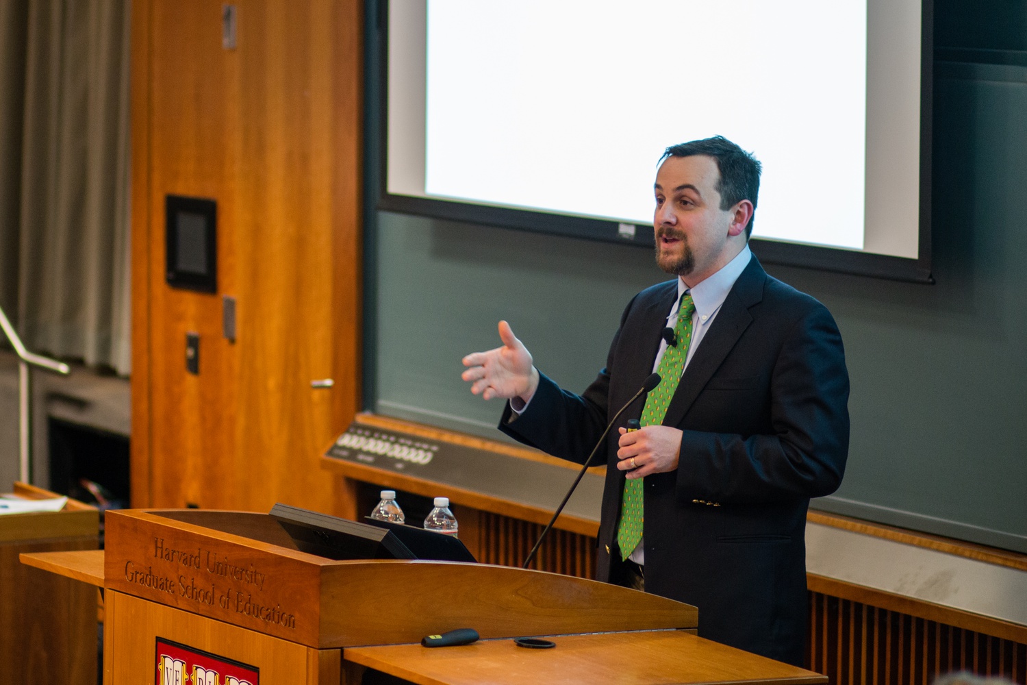 Justin Reich, HarvardX Research Fellow, highlights the distinction between the classroom and online settings when analyzing figures such as viewership and certification numbers. The HarvardX Research Presentation occurred on January 21 at Larsen Hall.
