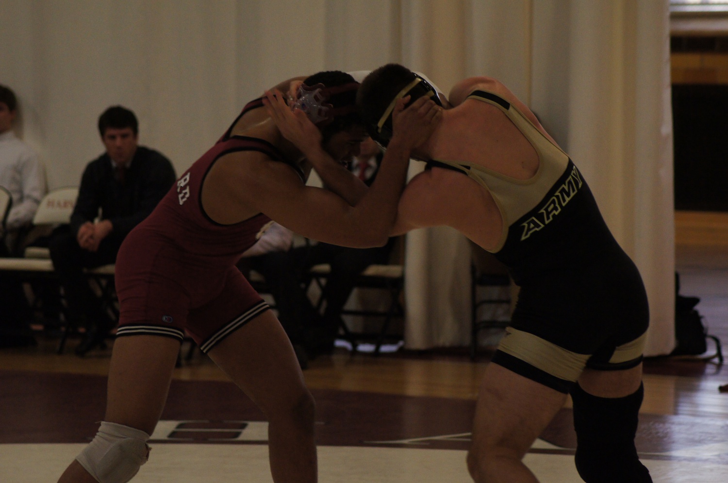 Harvard received a crucial pin from junior co-captain James Fox, shown here in previous action, wrestling against Boston University.