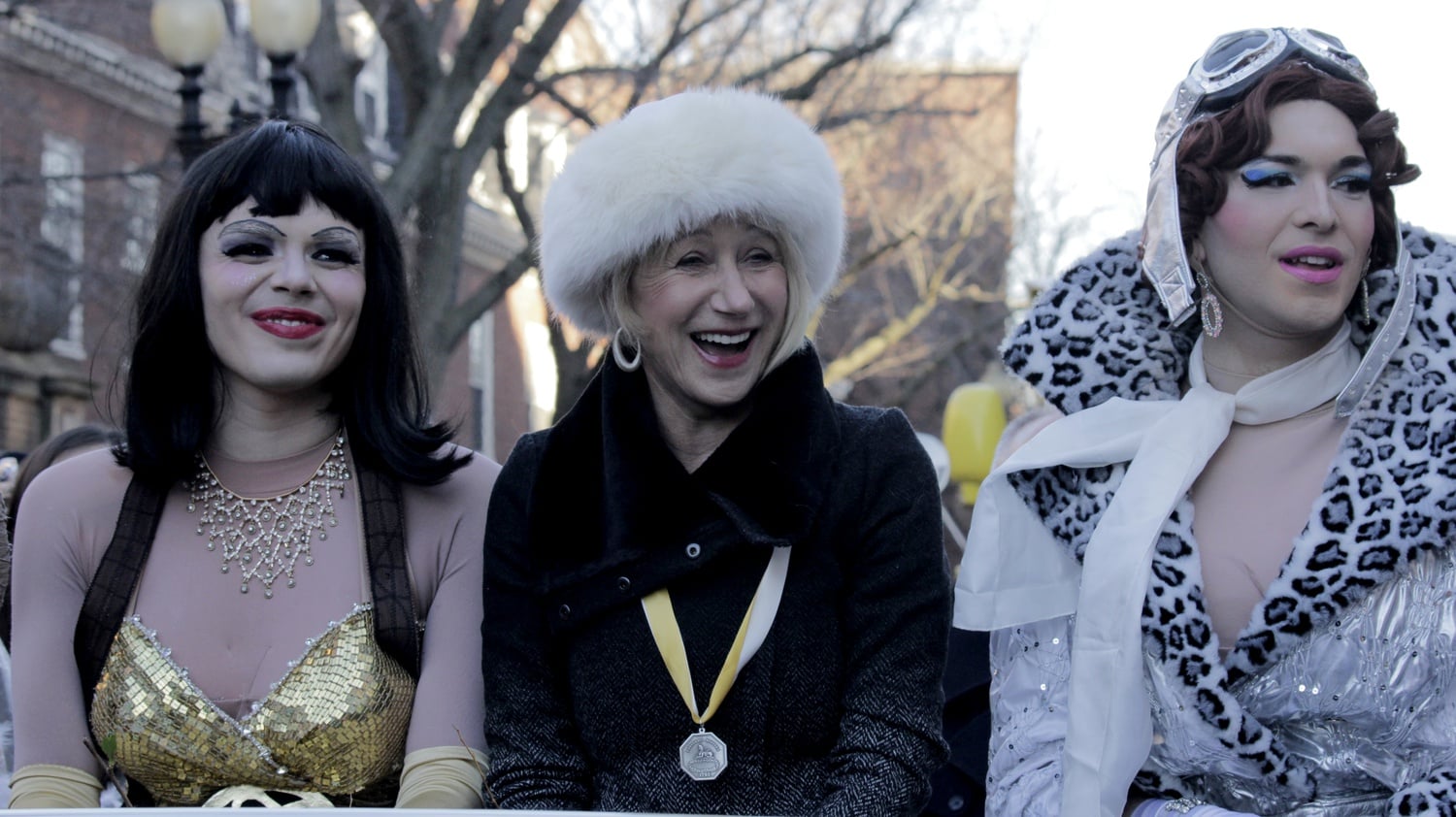 Helen Mirren laughs during the Hasty Pudding Theatricals' Woman of the Year Parade down Massachusetts Ave. on Thursday afternoon.