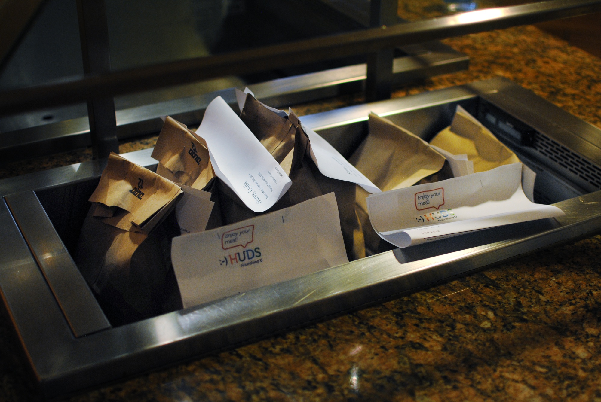 Refrigerated bagged lunches sit in the Cabot House dining hall on Feb. 3. Students can pick up a pre-ordered lunch in the morning if they're pressed for time. 