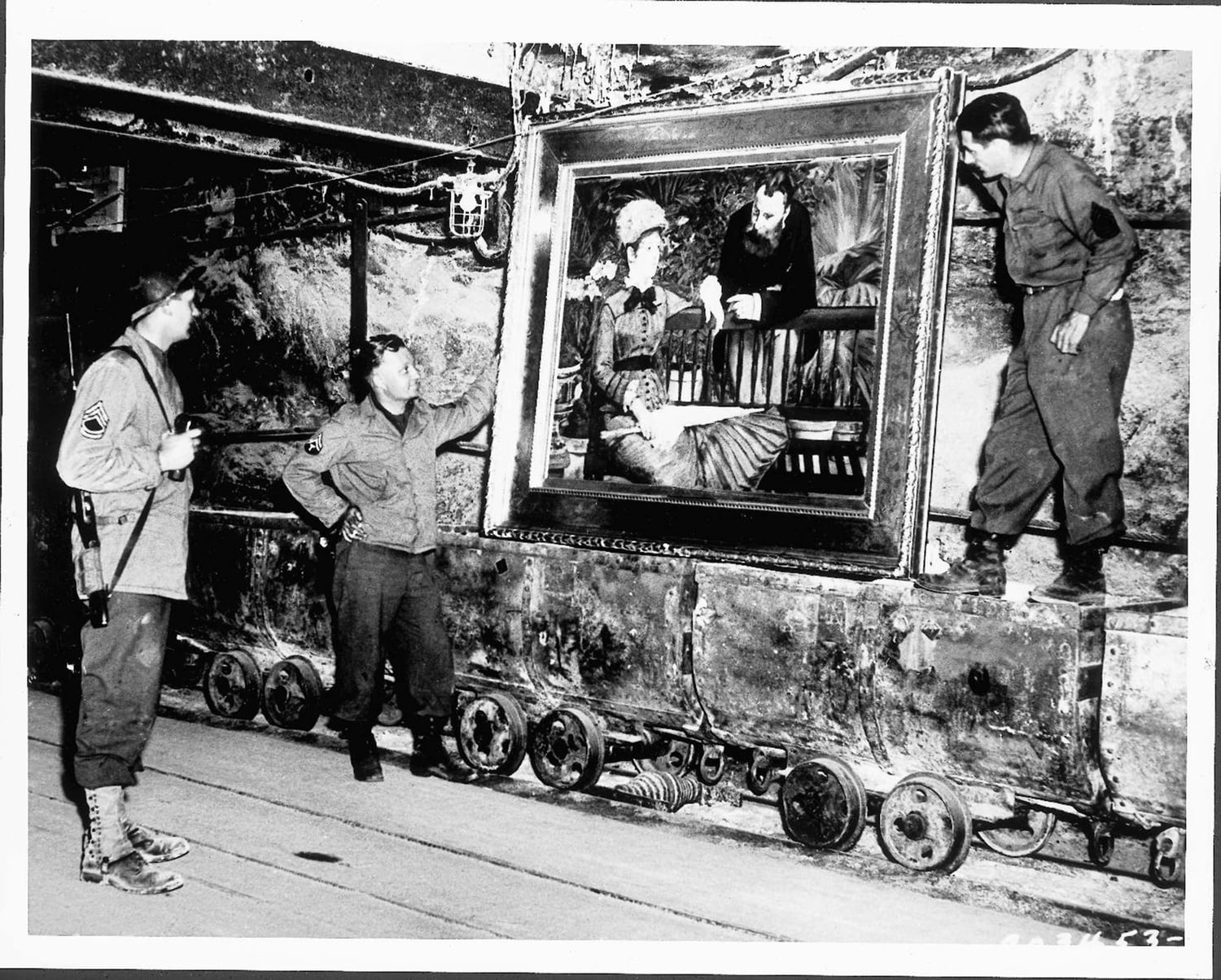 American soldiers with a recovered Manet painting in a salt mine.