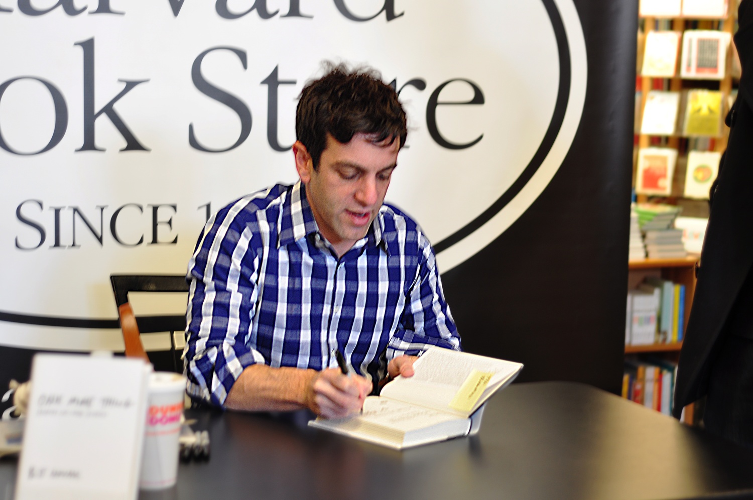 Author B.J. Novak '01 signs a copy of his new book, "One More Thing: Stories and Other Stories" at his public book signing at the Harvard Book Store on Feb. 10.