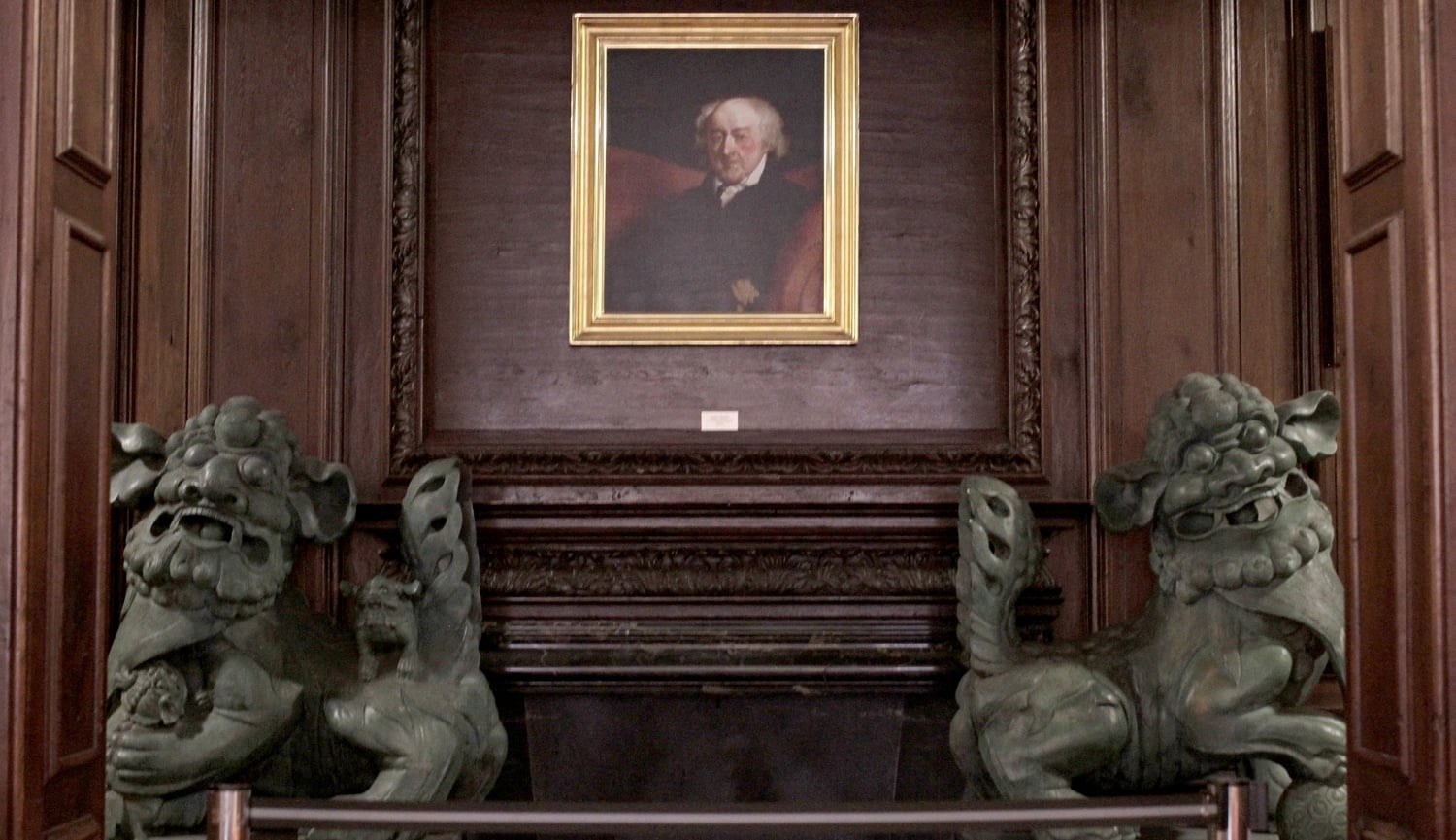 A portrait of John Adams hangs between two Chinese dragon sculptures in Adams House.