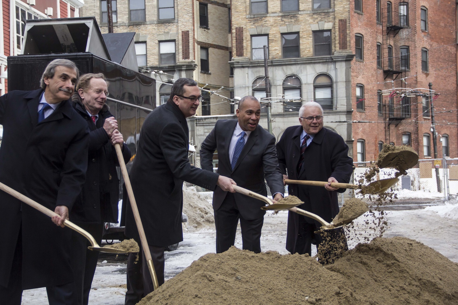 Governor Deval L. Patrick ‘78, center right, breaks the ground along with members of the redevelopment project at 114 Mt. Auburn St. last Wednesday, Feb. 20, 2014. The area is going to be developed into an office building leased primarily by the university.