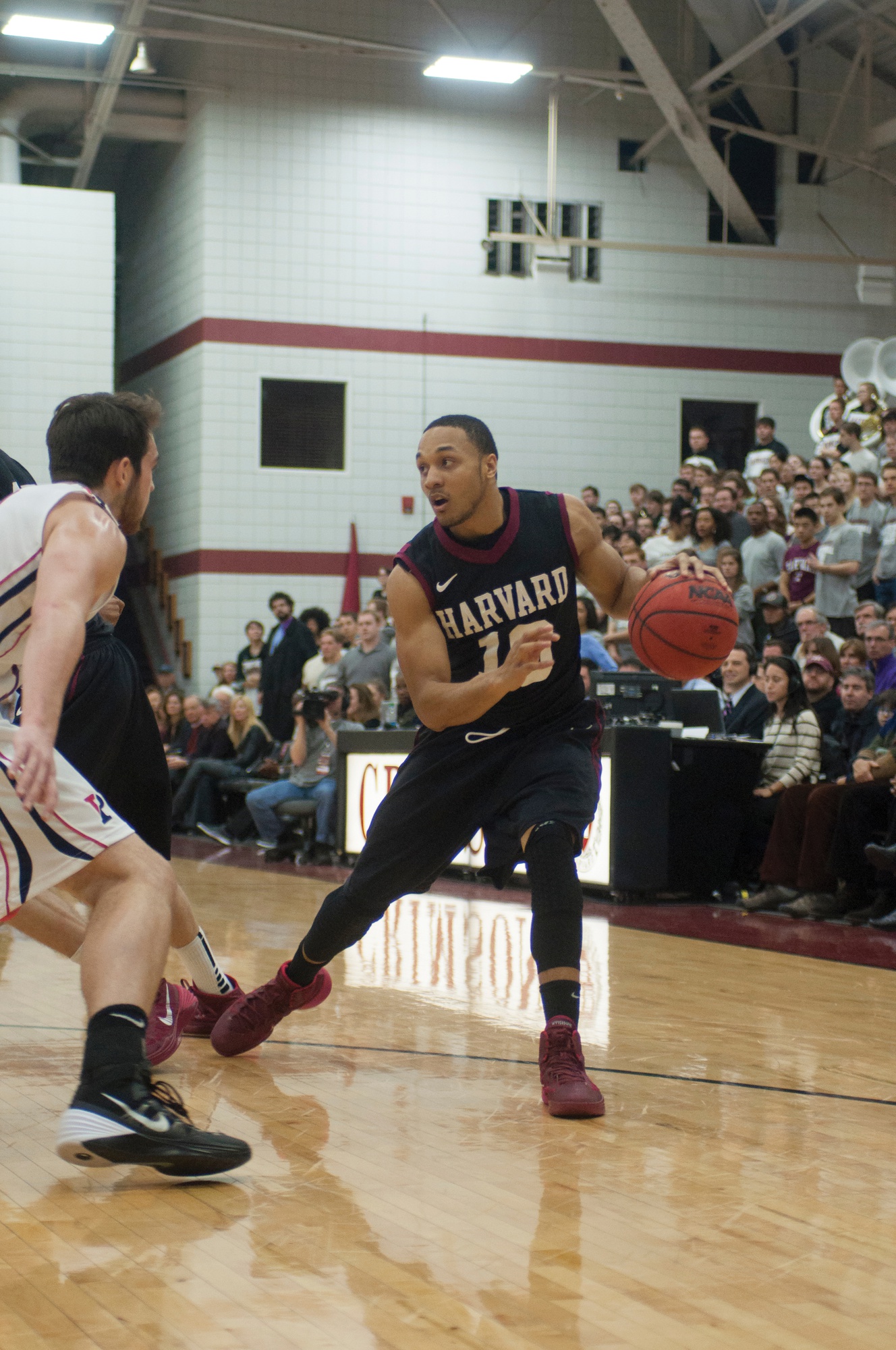 Co-captain Brandyn Curry, shown here in earlier action, has nine points in the team's first half against Yale. Harvard leads, 36-23.