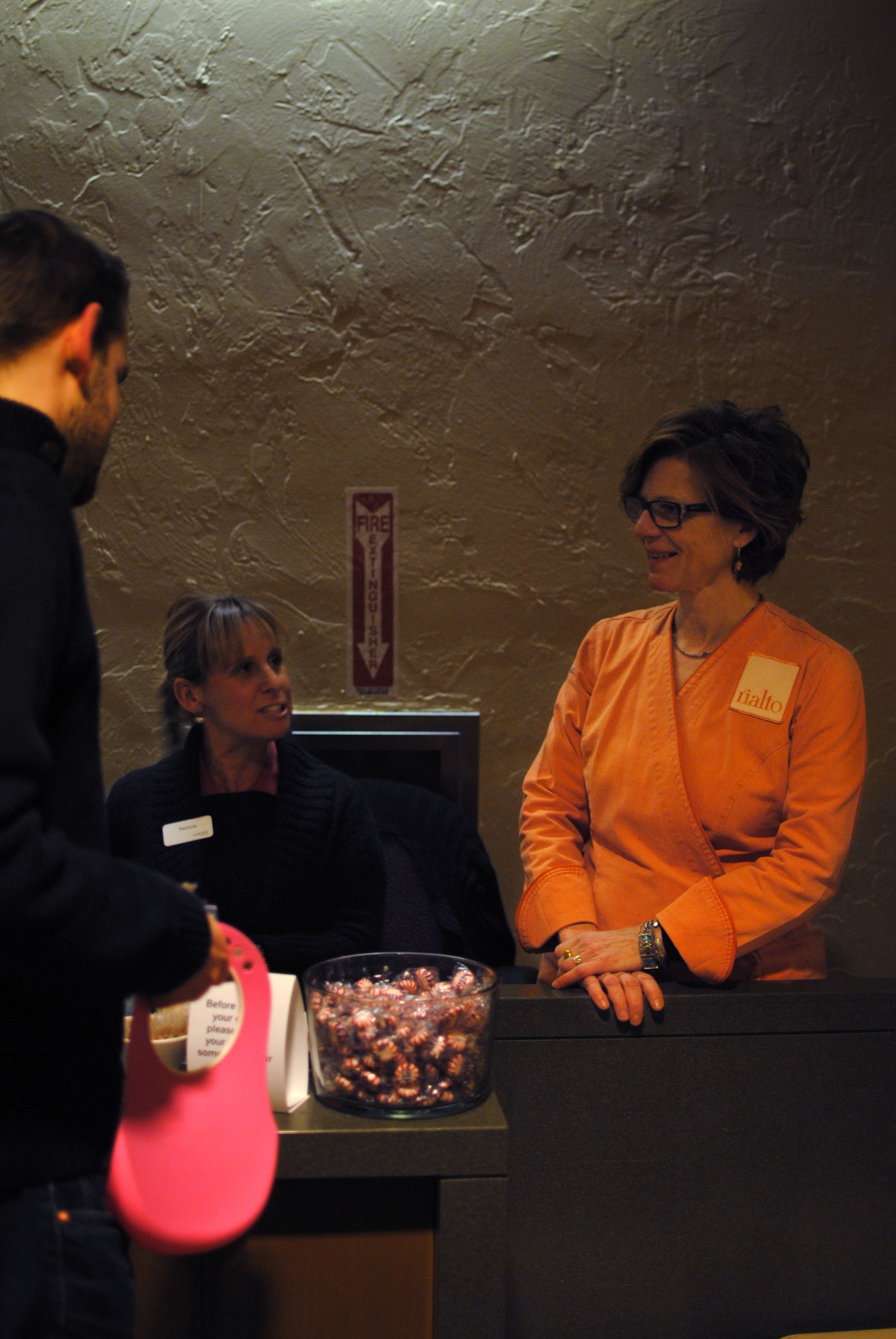 Jody Adams, right, head chef of Rialto in Harvard Square, talks with students as they swipe into Currier dining hall on Feb 28. HUDS asked Adams to plan a menu for all dining halls to serve for dinner on Friday night.