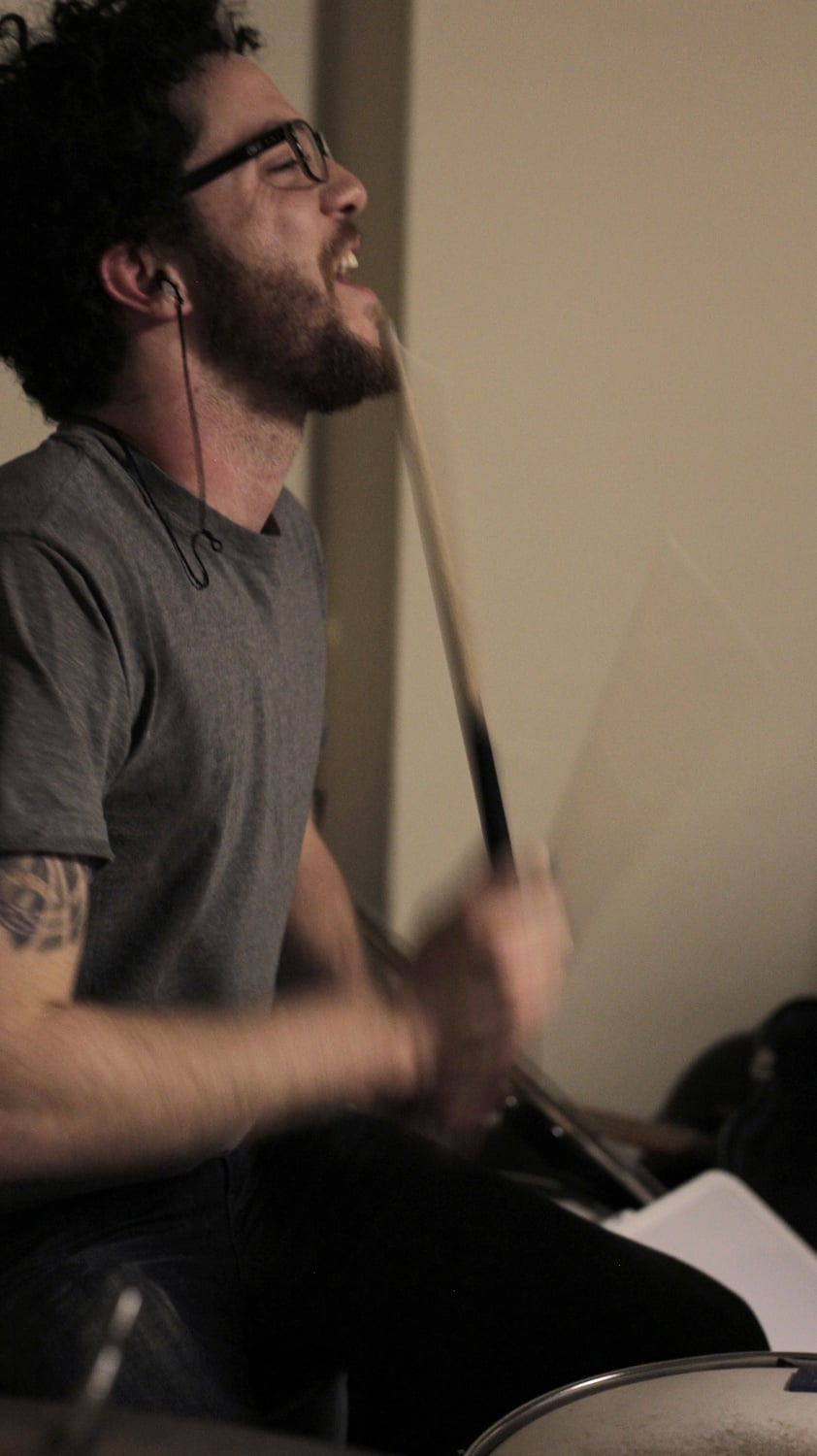 Will Sissle of L.A. Jeff plays drums during band practice in the Lowell House basement.
