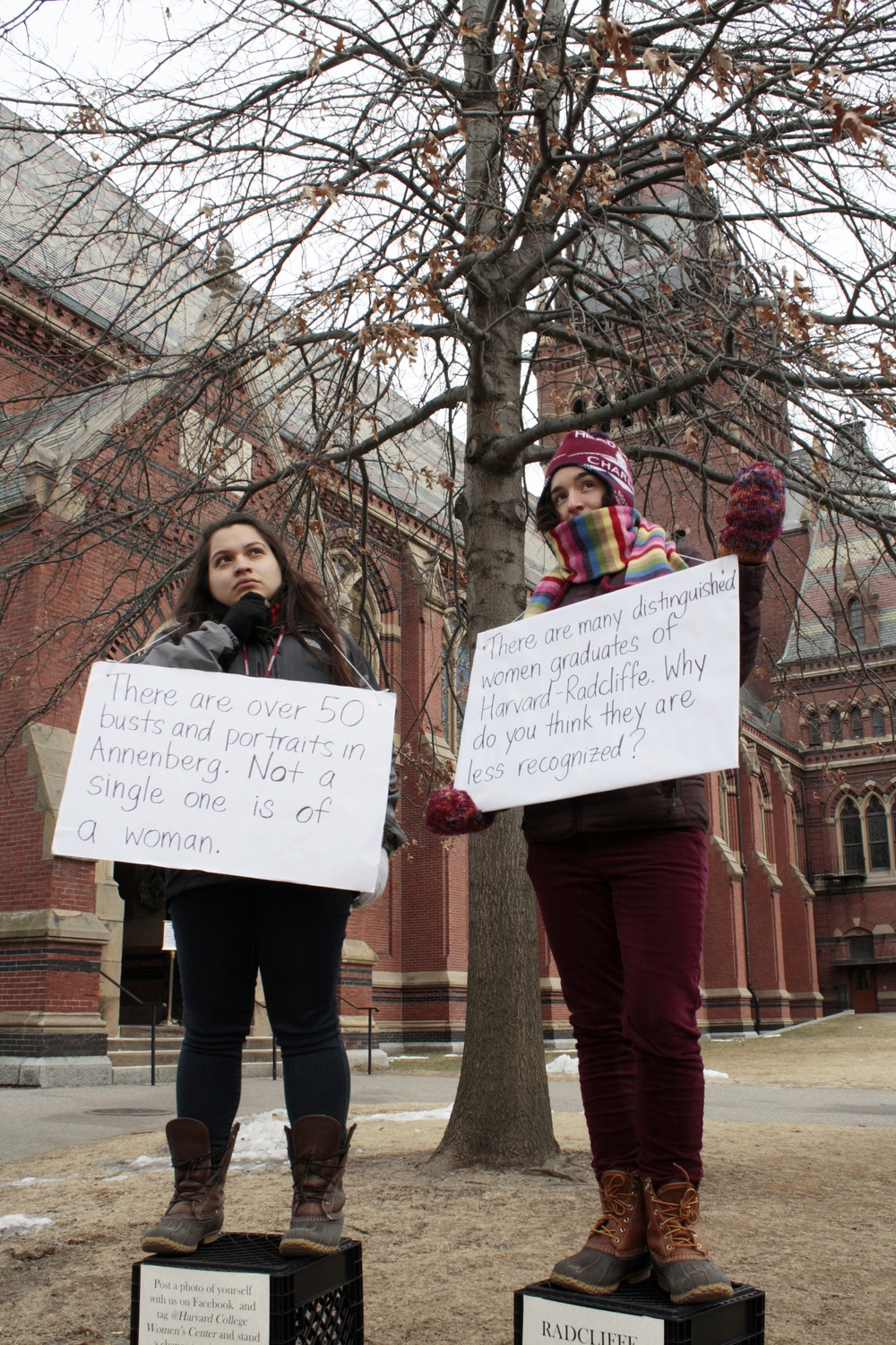 Neimy K. Escobar '15 and Devi K. Lockwood '14 pose as statues in front of Annenberg on Tuesday afternoon. As part of Women's Week 2014, the goal was to promote discussion about the role of gender at Harvard.