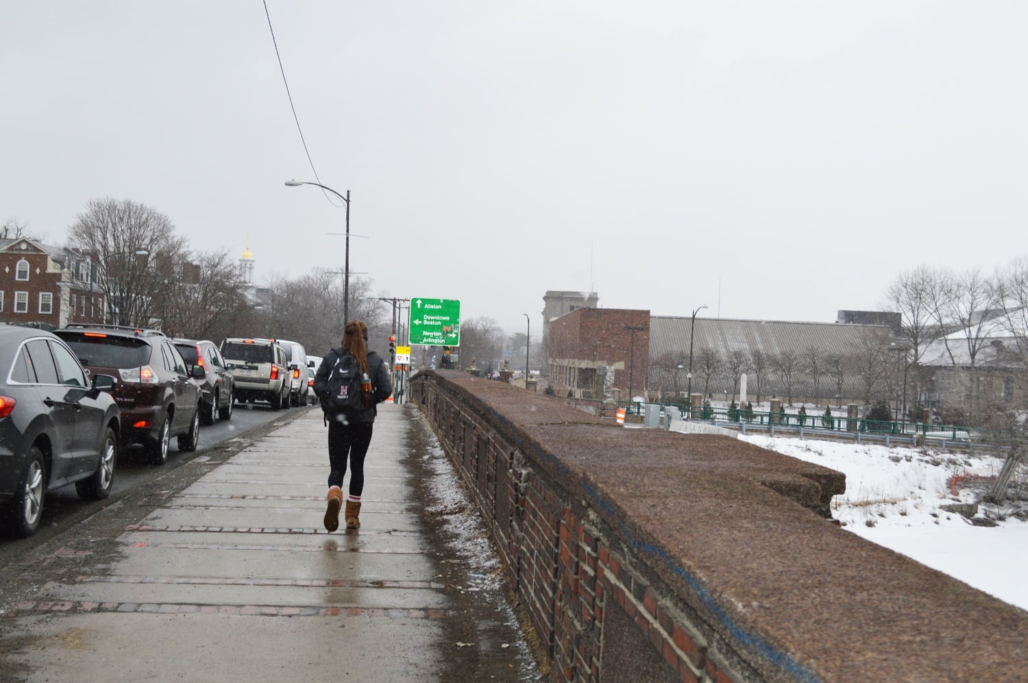 A member of the women's hockey team jogs across Anderson Bridge to get to practice.