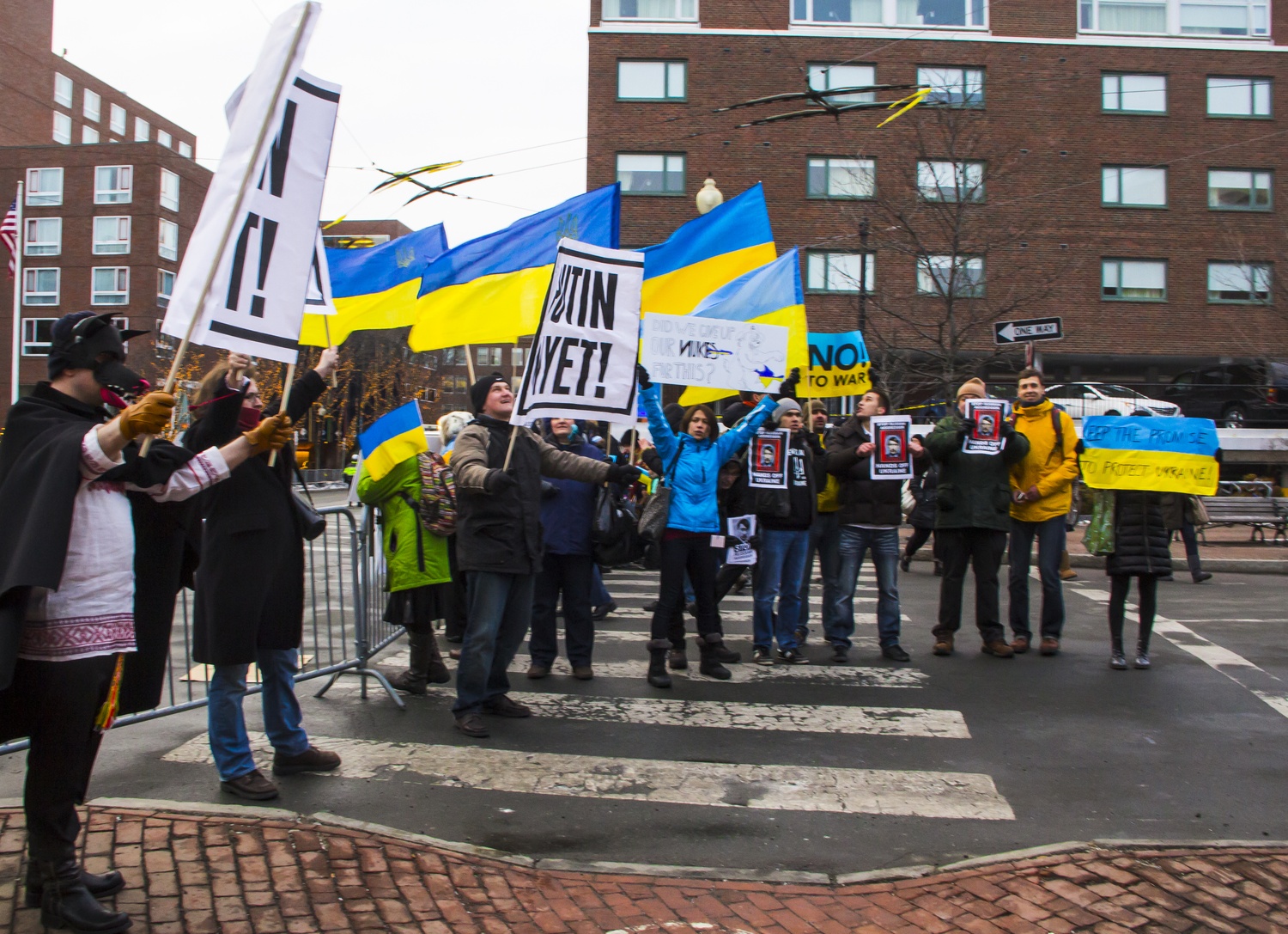Protesters gather in front of the Charles Hotel Wednesday, March 5, to call on the U.S. to take a more aggressive stance against the Russian presence in the Crimean region. President Obama arrived in Cambridge during the afternoon to raise money for the Democratic National Committee.