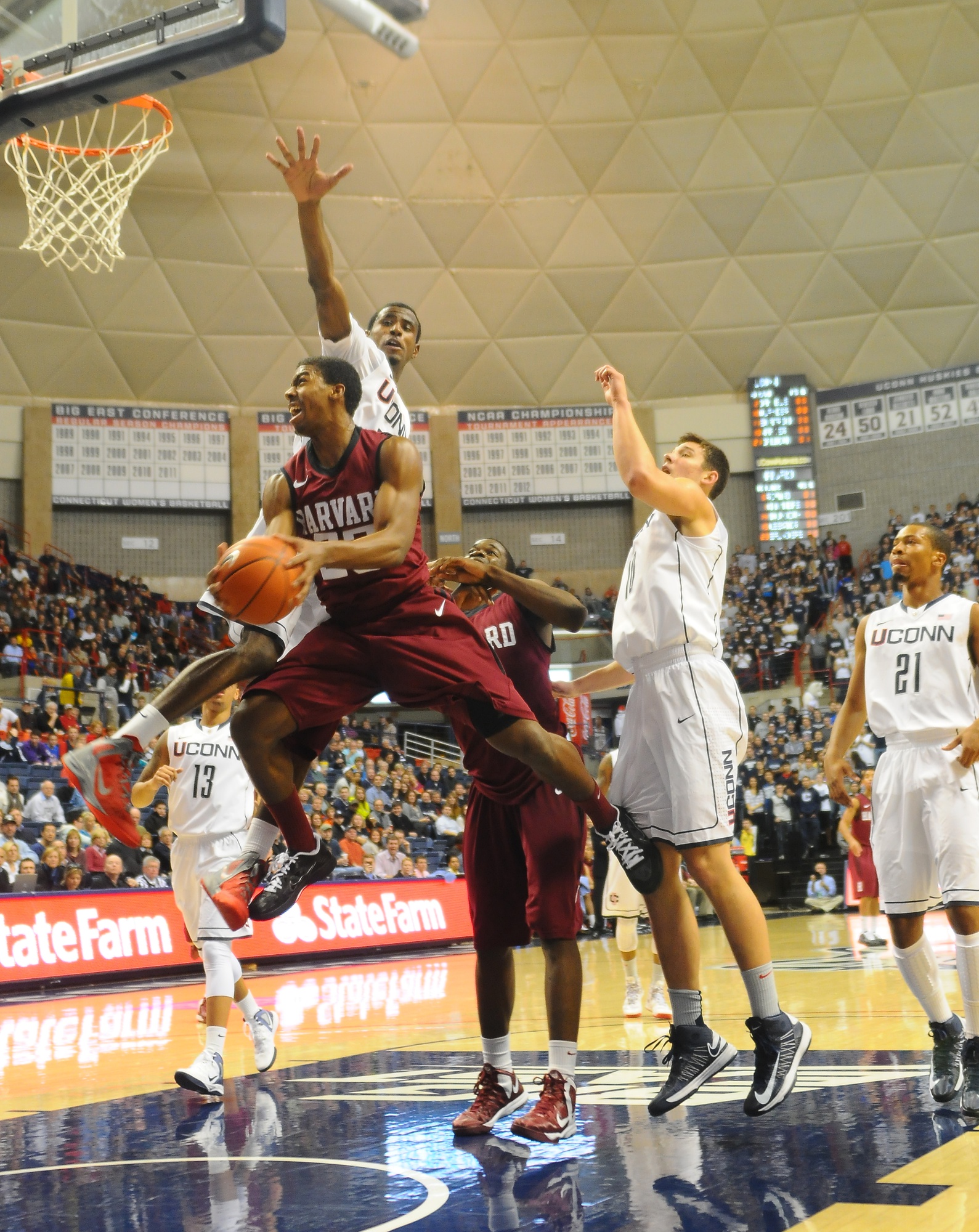 Connecticut is the only common opponent of Harvard and Cincinnati. Junior wing Wesley Saunders, shown above against the Huskies, will be key in a potential upset.