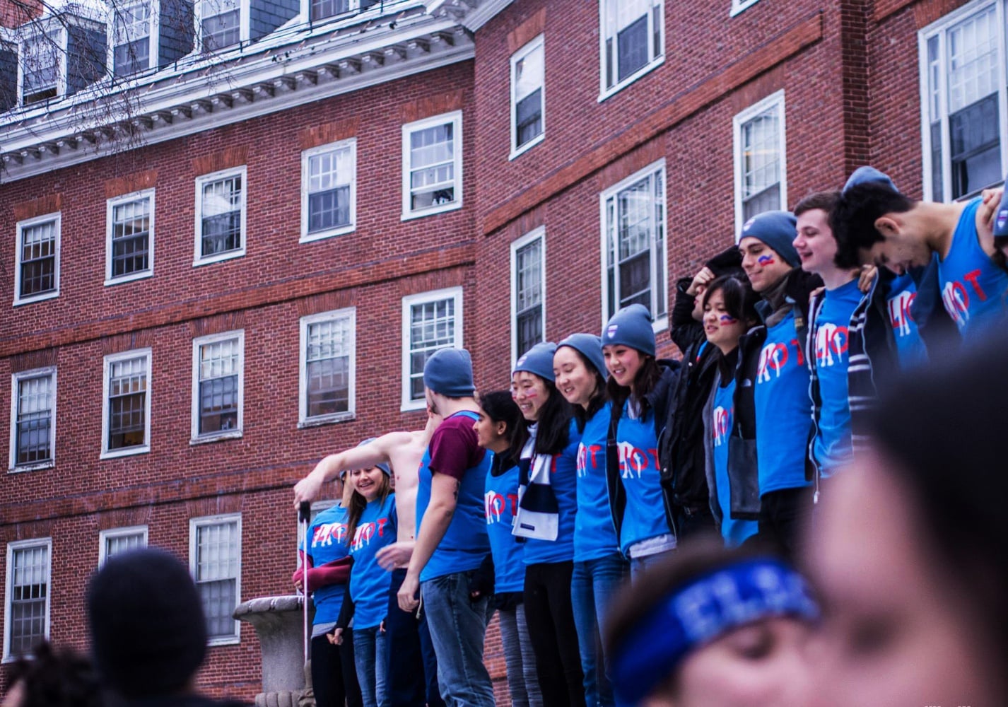 Eliot House students celebrate outside their House before storming the Yard on the morning of Housing Day.