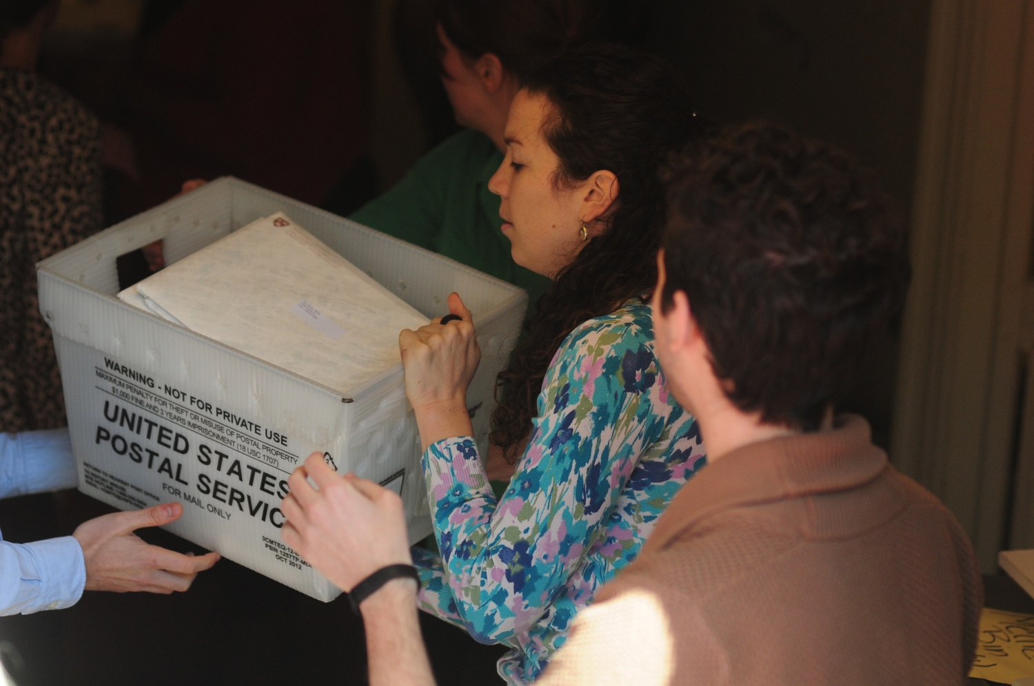 Members of the Admissions Office hand off the boxes of acceptance letters.