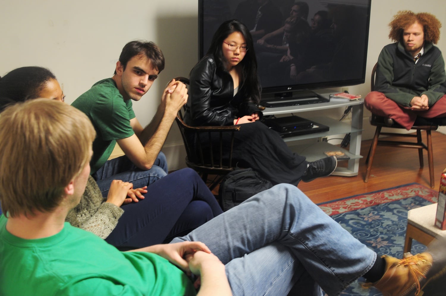 Ben S. Kuhn '15, Angie Jo '16, and Aaron D. Tucker '16 of Harvard College Effective Altruism discuss Atheist Coming Out Week in the Adams Diaspora Room on Wednesday evening.