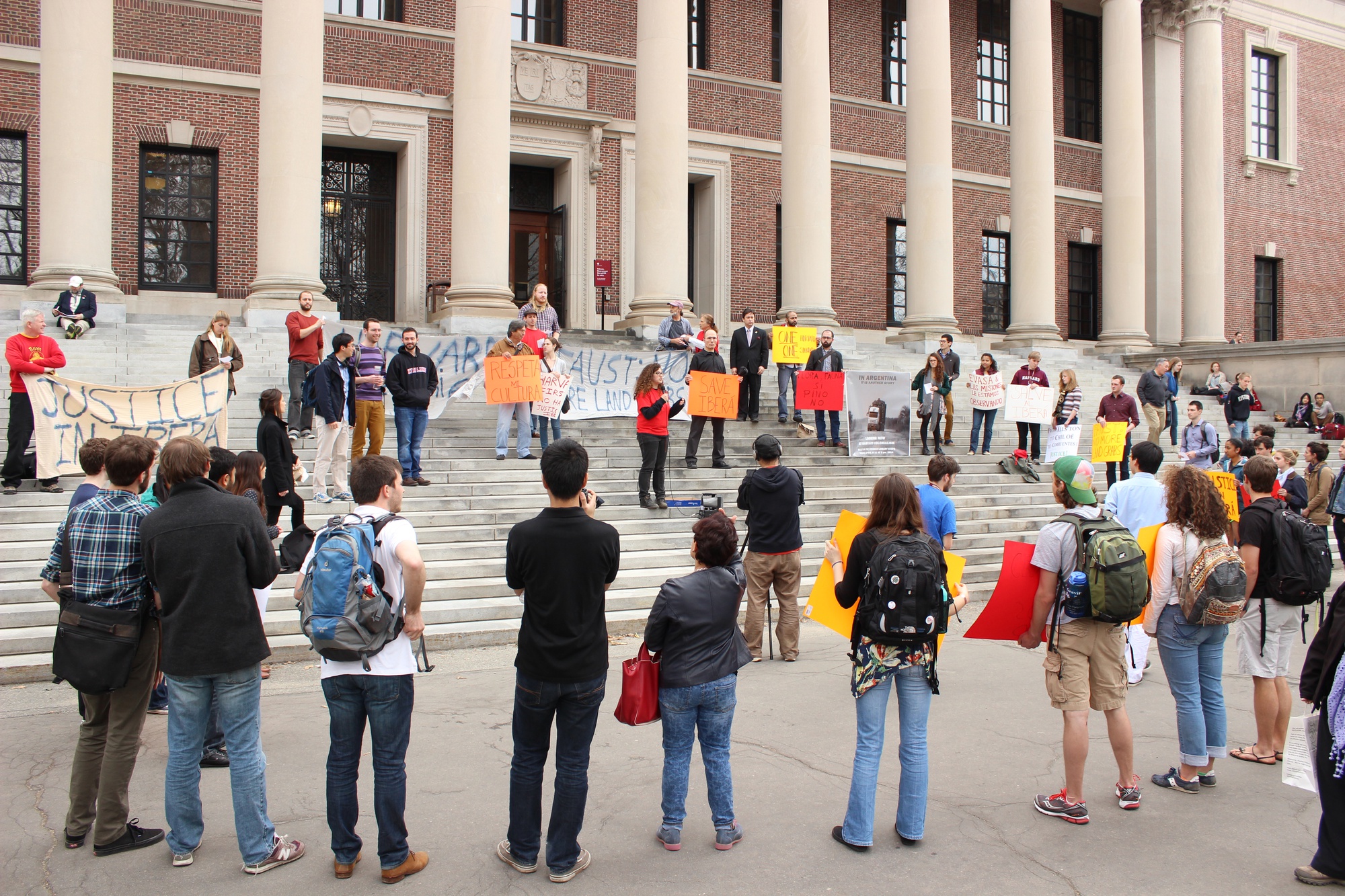 Sandra Korn '14, a leader for the Responsible Investment at Harvard Coalition, speaks to protesters gathered on the steps of Widener Library on Friday afternoon. The rally protested Harvard's management of its timber plantations in northern Argentina and ended in a protest in front of Massachusetts Hall. 