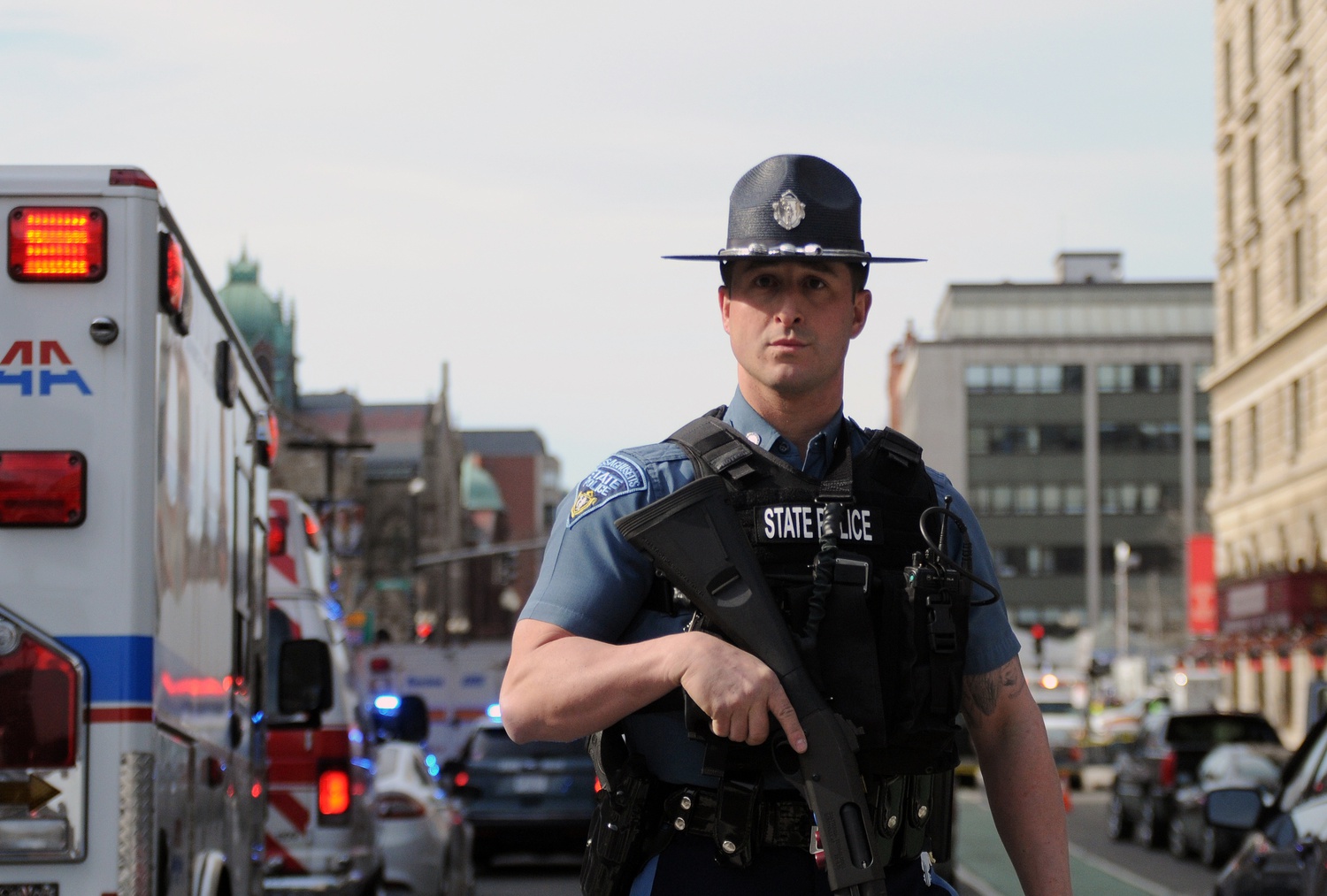 A Massachusetts State Police officer blocks a road in downtown Boston Monday afternoon following the two explosions. 