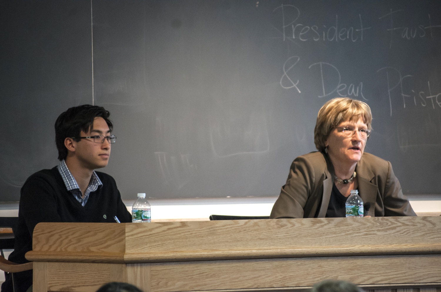UC Vice President Sietse K. Goffard ‘15, left, listens to University President Drew G. Faust as she answers a question during an open meeting with the student body.