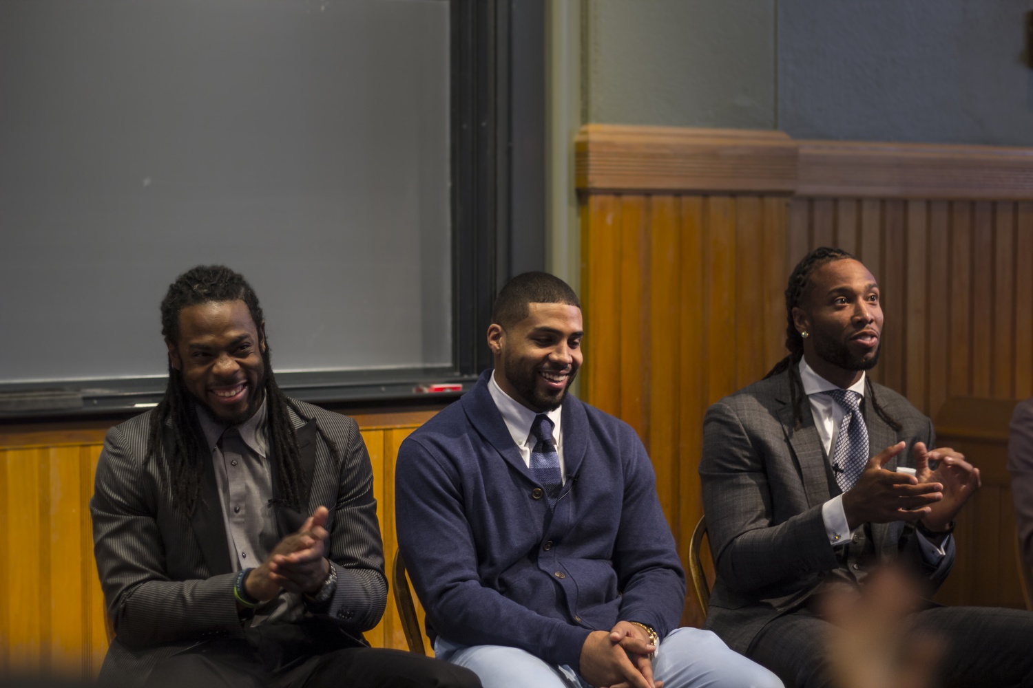 Richard K. Sherman, left, Arian I. Foster, center, and Larry D. Fitzgerald, right, discuss their experiences during their collegiate years as student athletes and the difficulties they faced balancing academics and football.