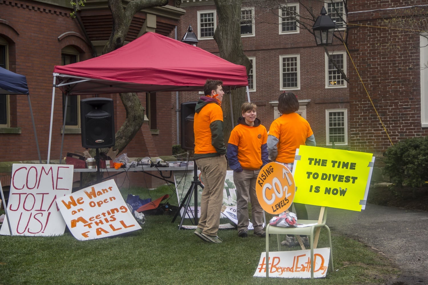 Divest Harvard activists gather in front of Massachussets Hall to protest against the University's continued investment in various fossil fuel companies.