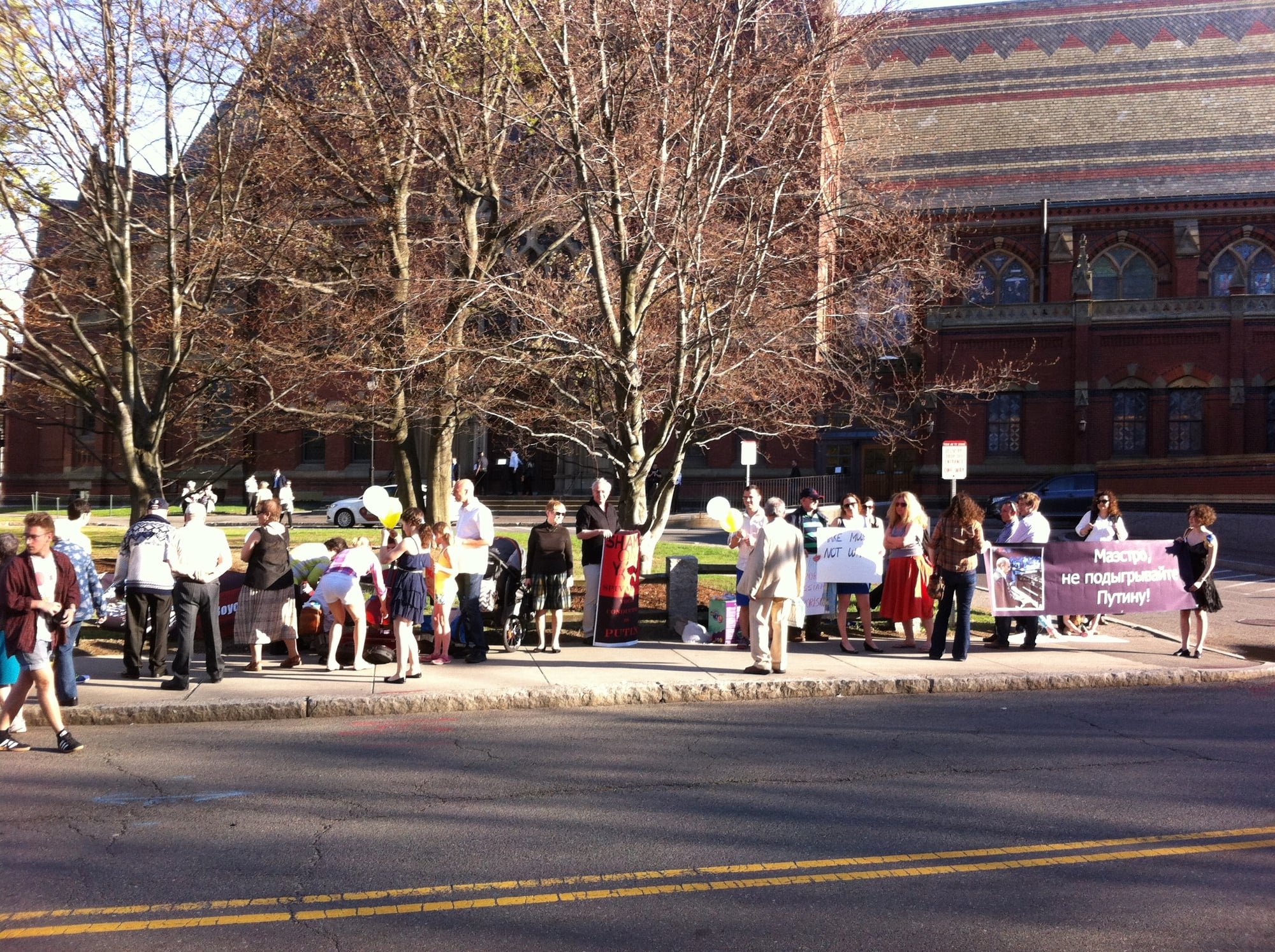 Protesters of violinist Vladimir T. Spivakov stand outside Memorial Hall on Sunday evening, where the Russian violinist was performing.