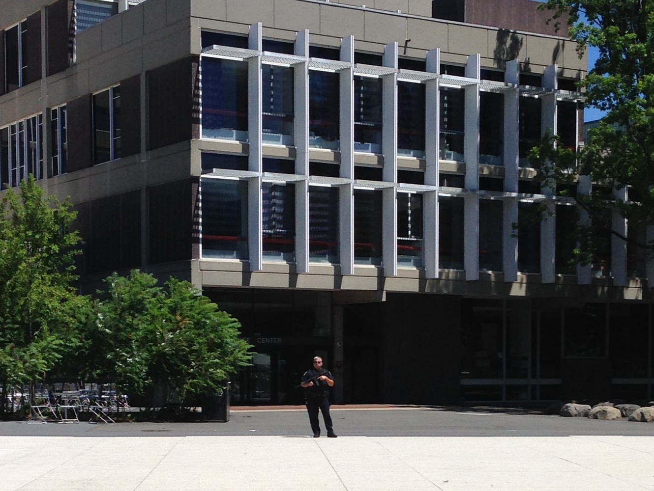 A lone armed guard stands watch in front of evacuated Science Center Saturday morning as police investigate bomb threats. 